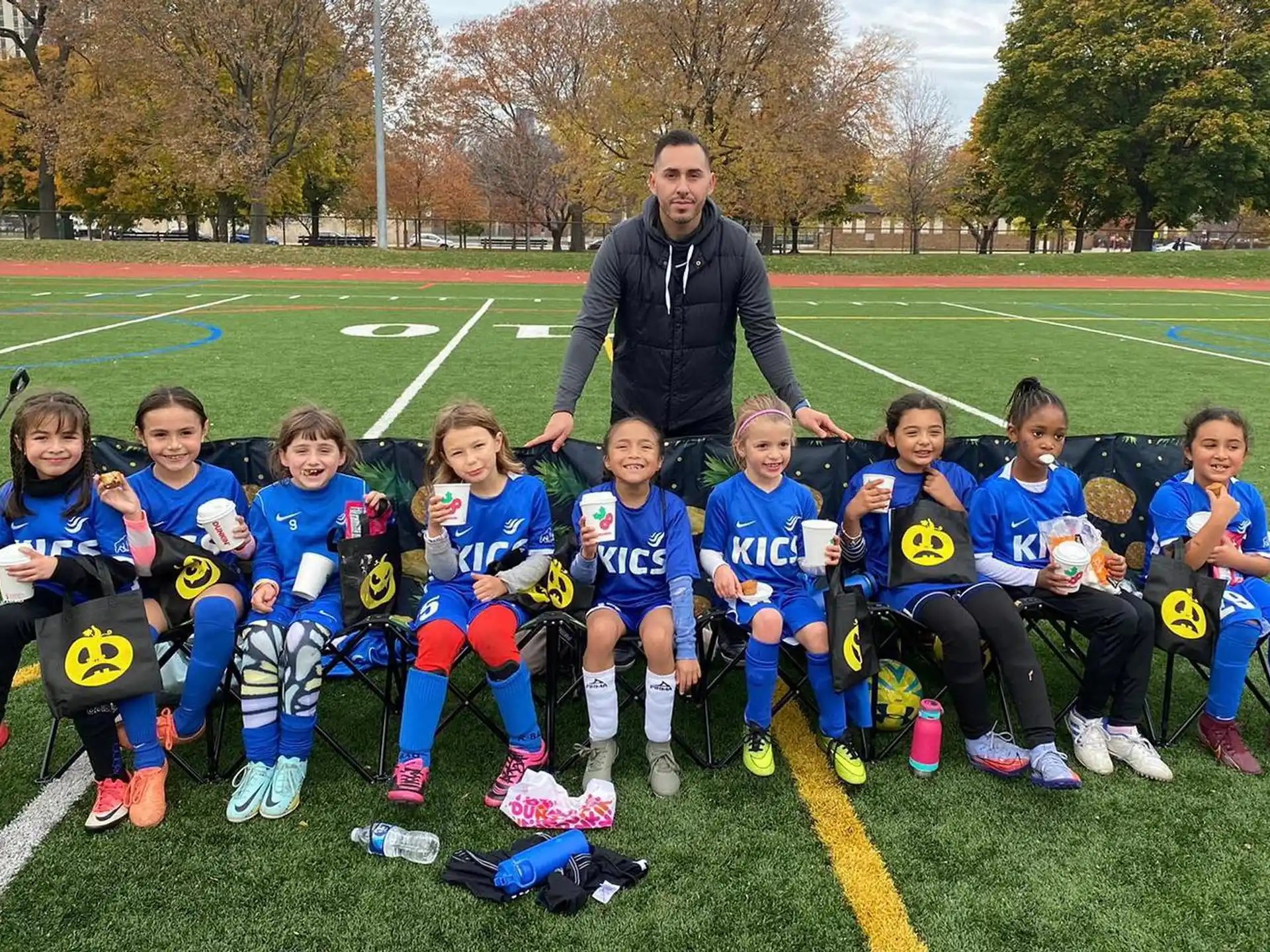 a group of kids posing for a photo on a football field