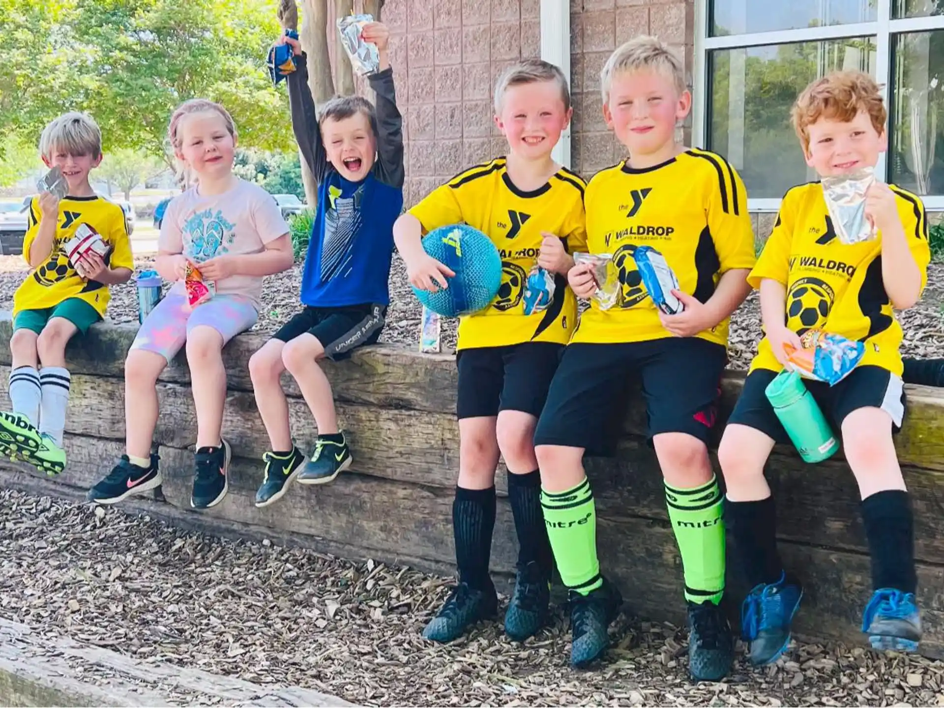a group of kids in football uniforms