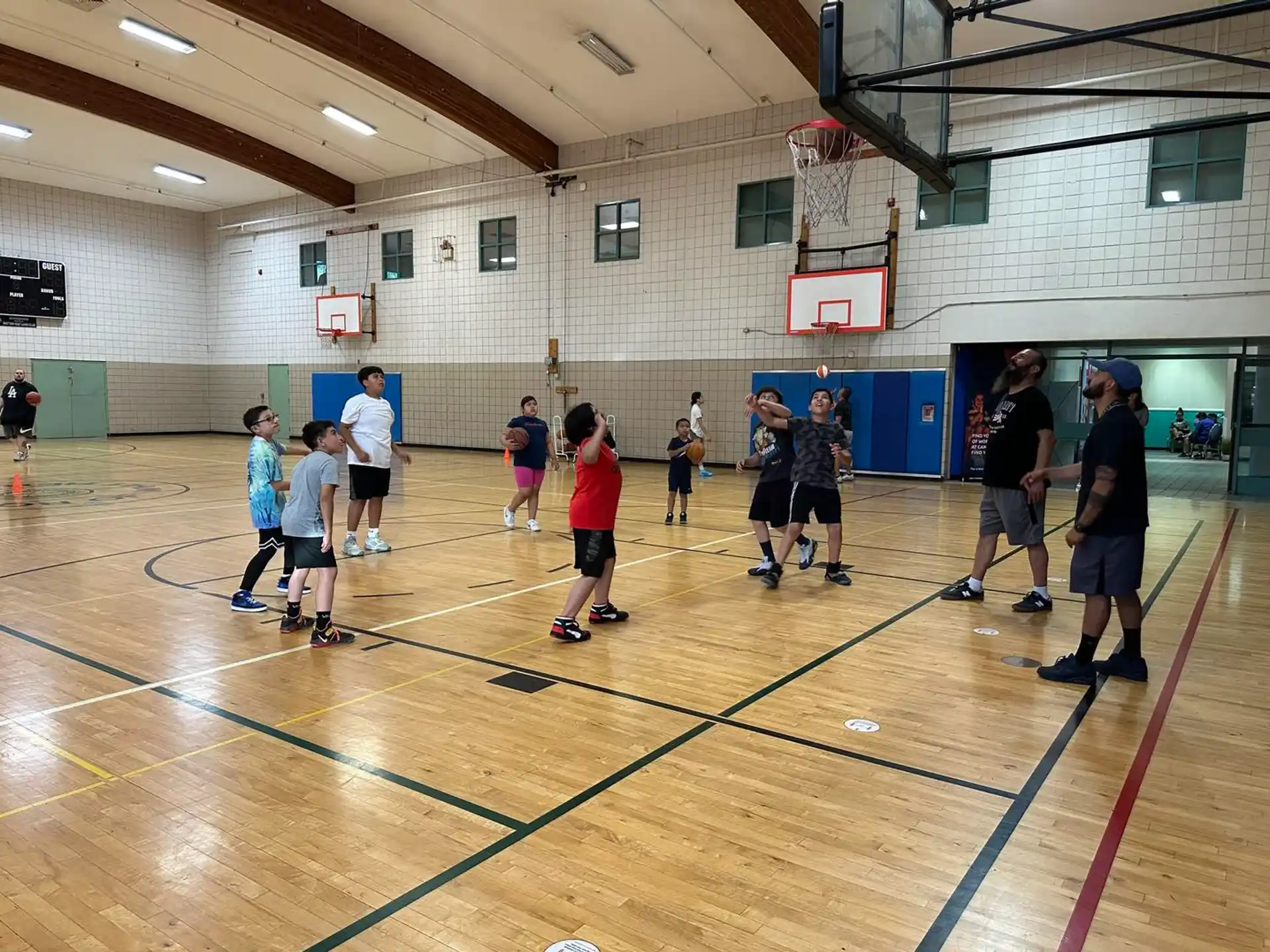 a group of people playing basketball