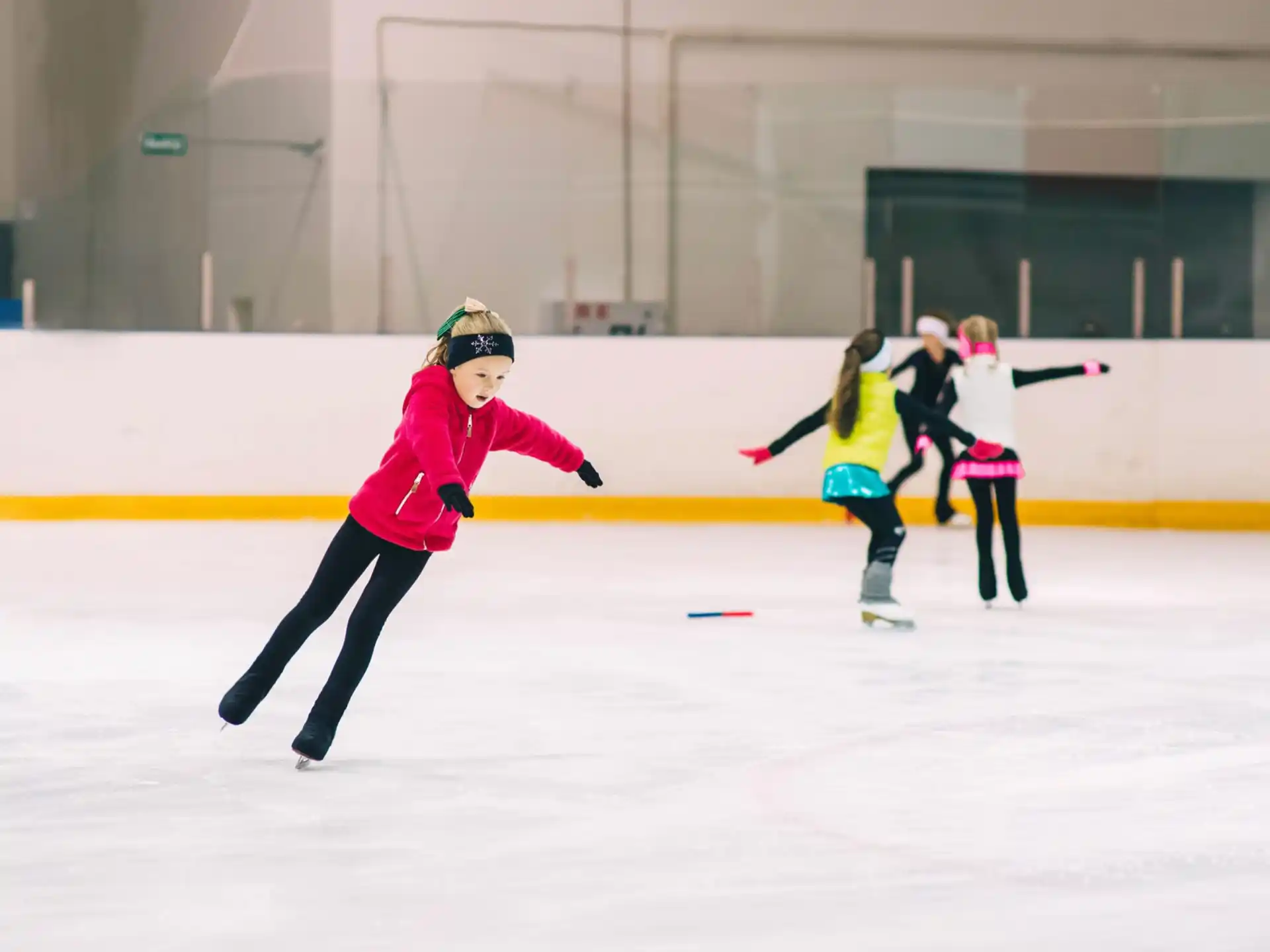 a group of women ice skating