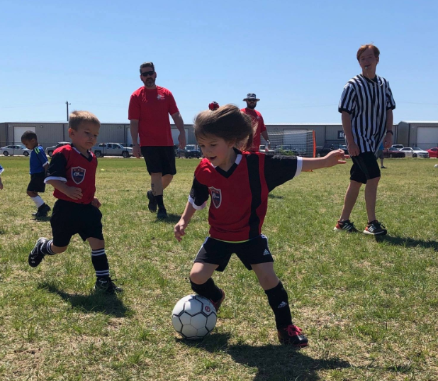 a group of kids playing football