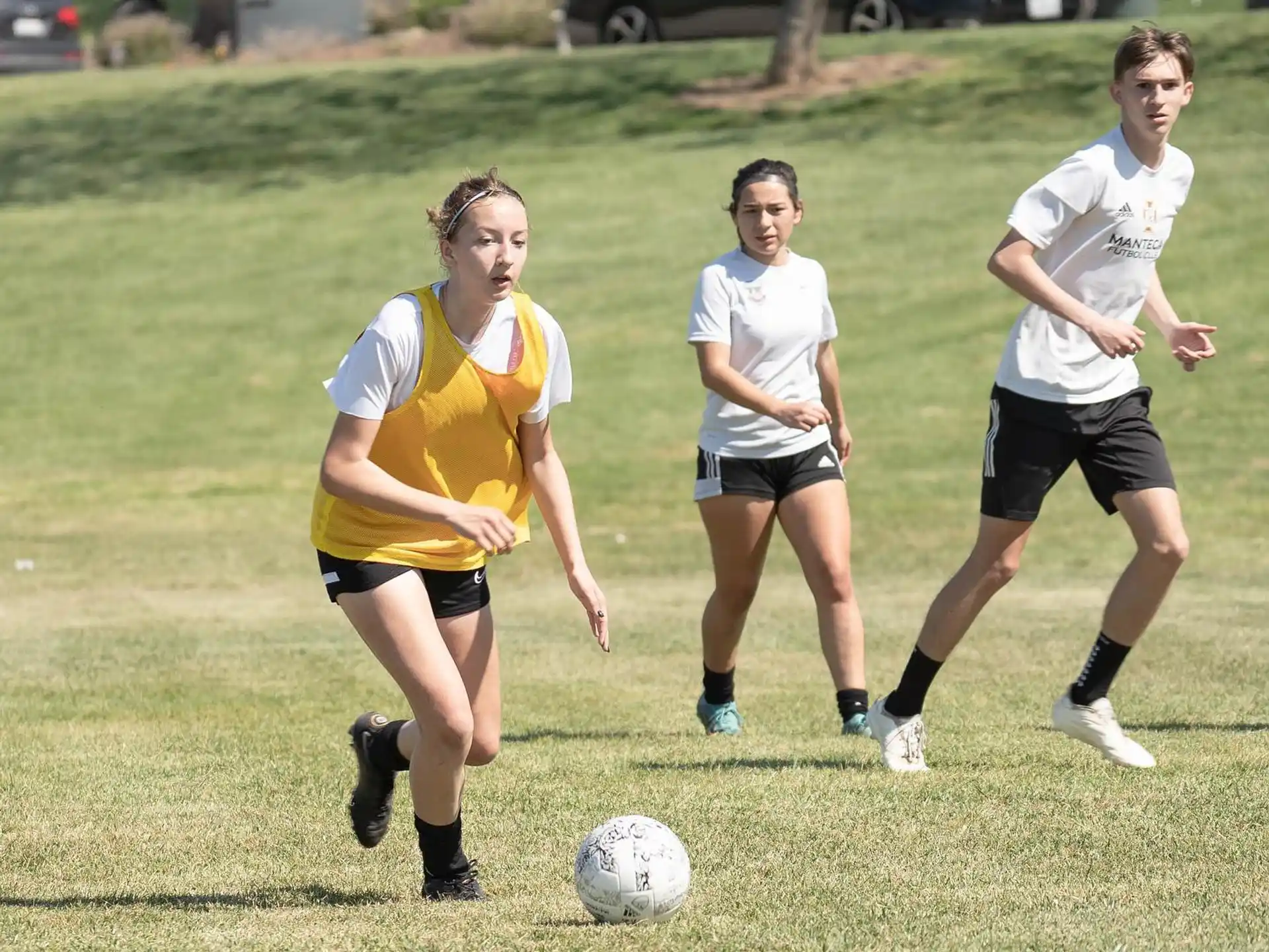 girls playing football on a field
