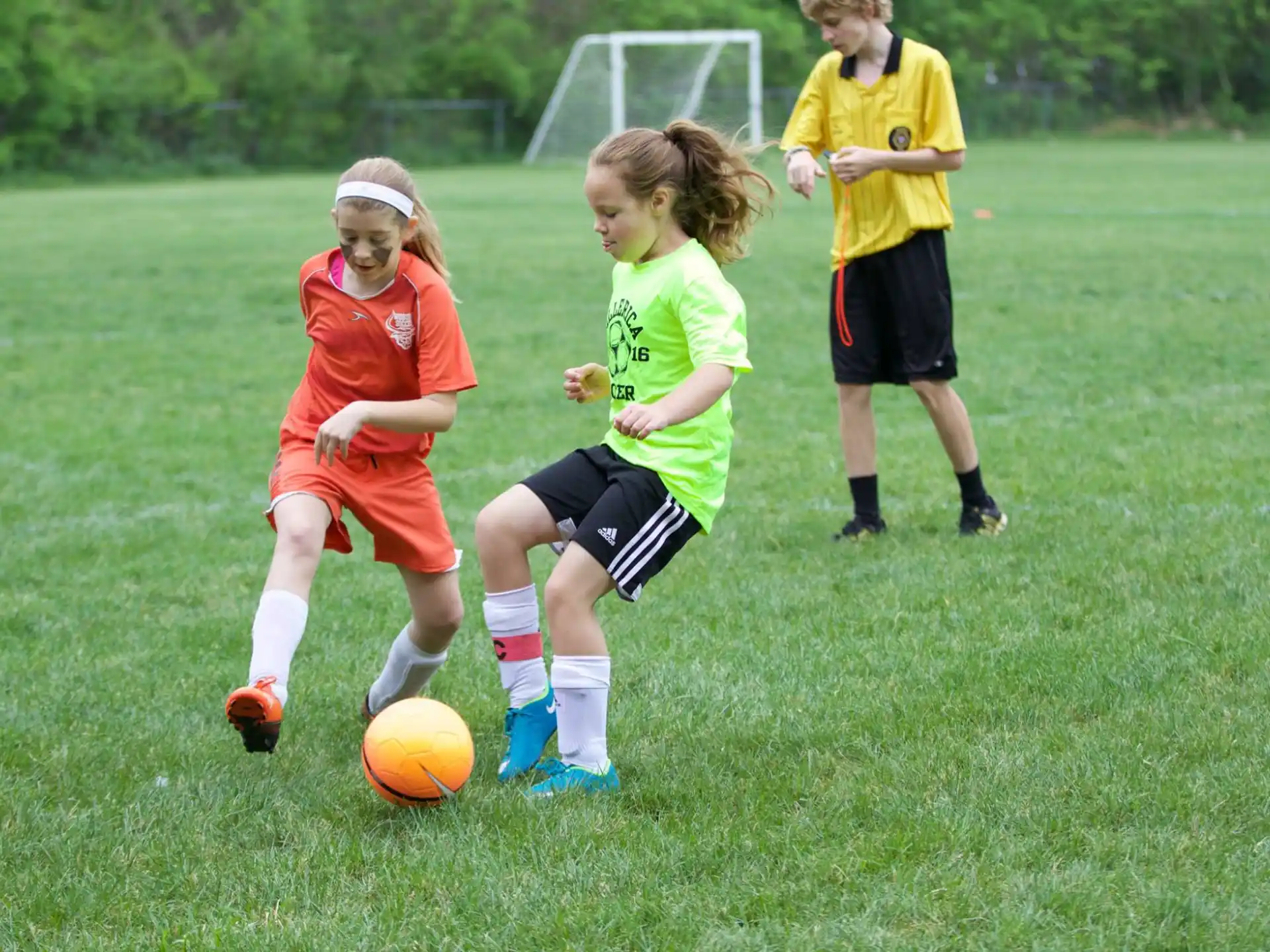 girls playing football on a field