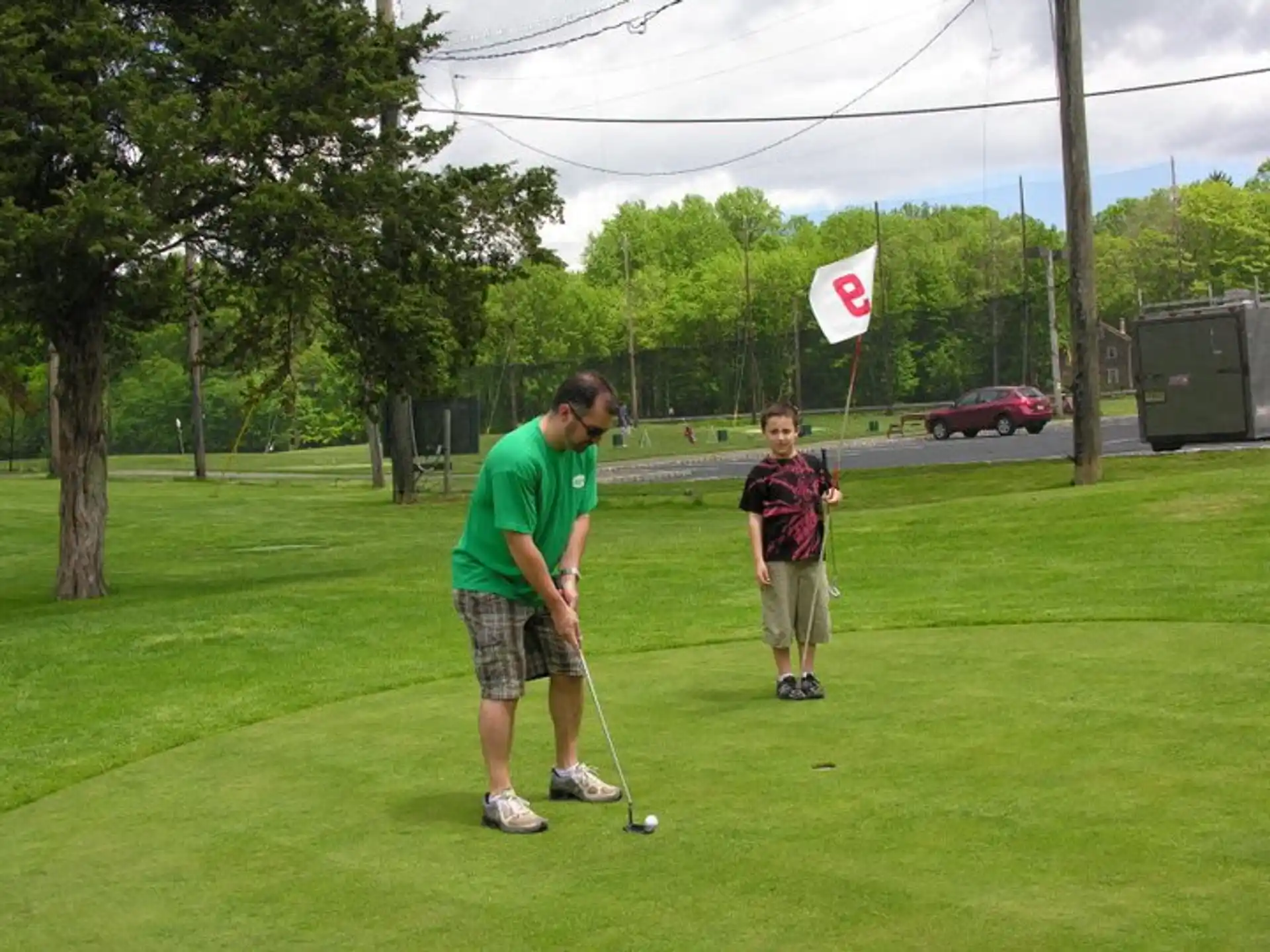 a man and a boy playing golf