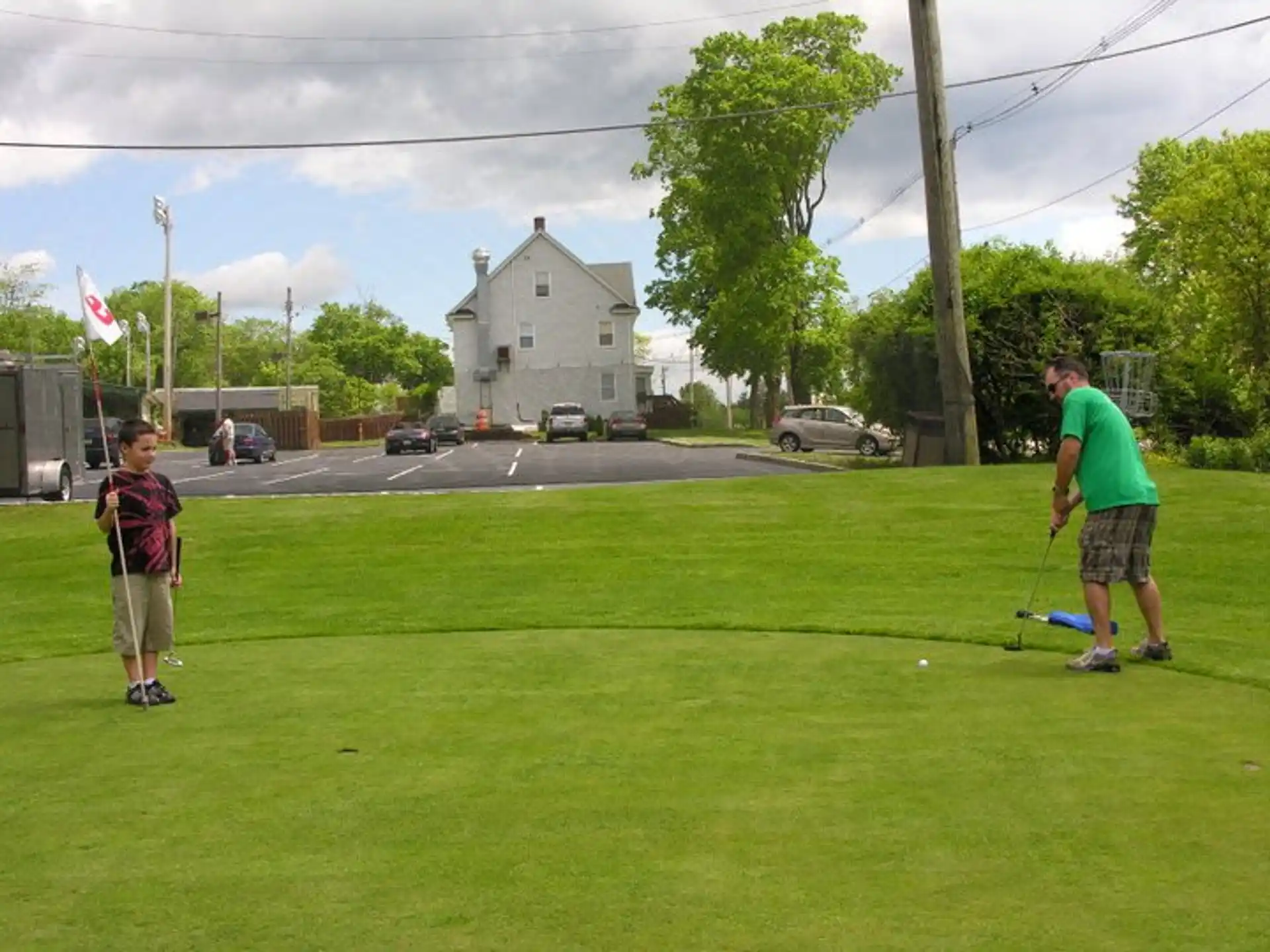 a person and a boy playing golf
