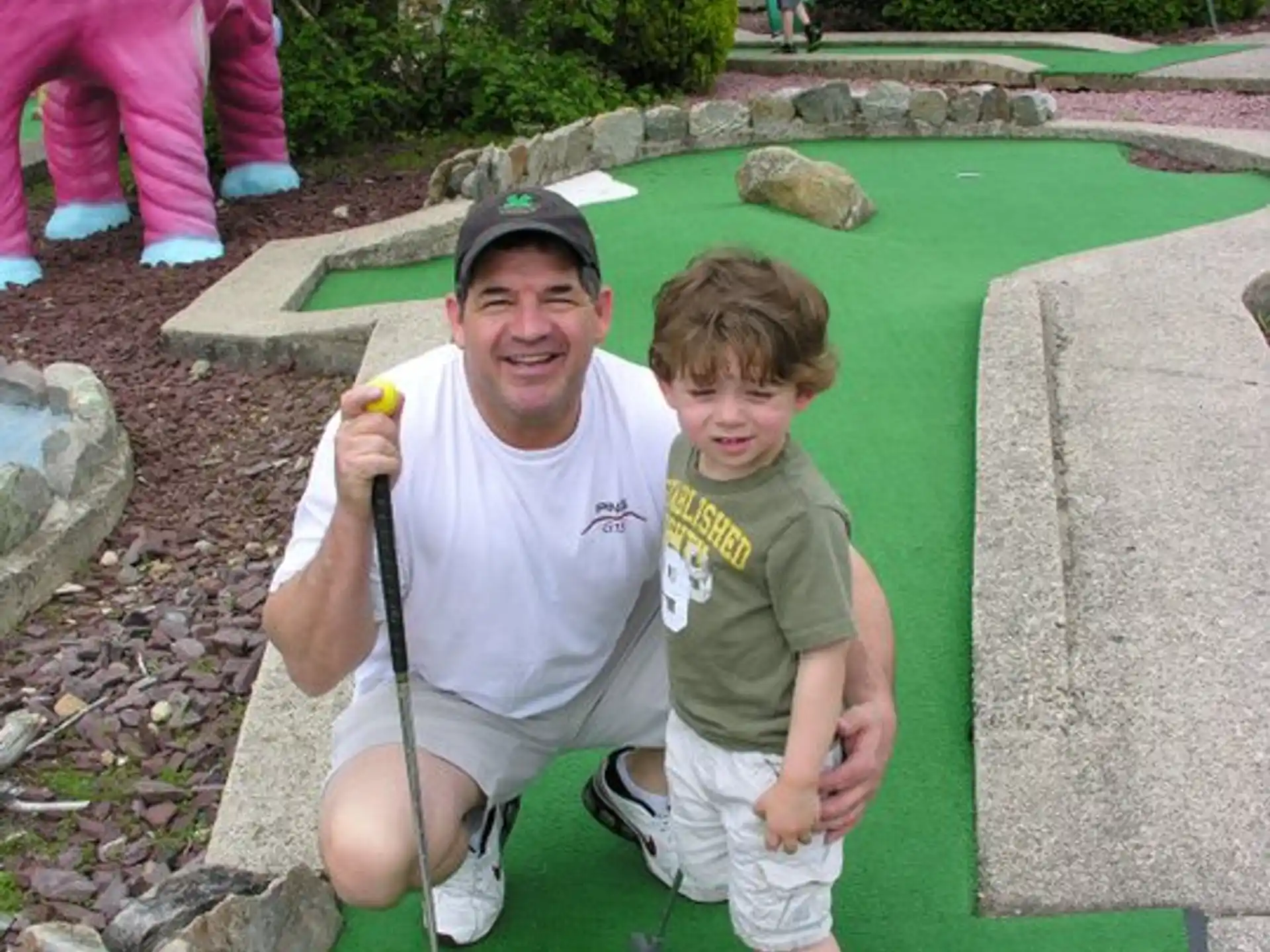 a person and a boy playing golf