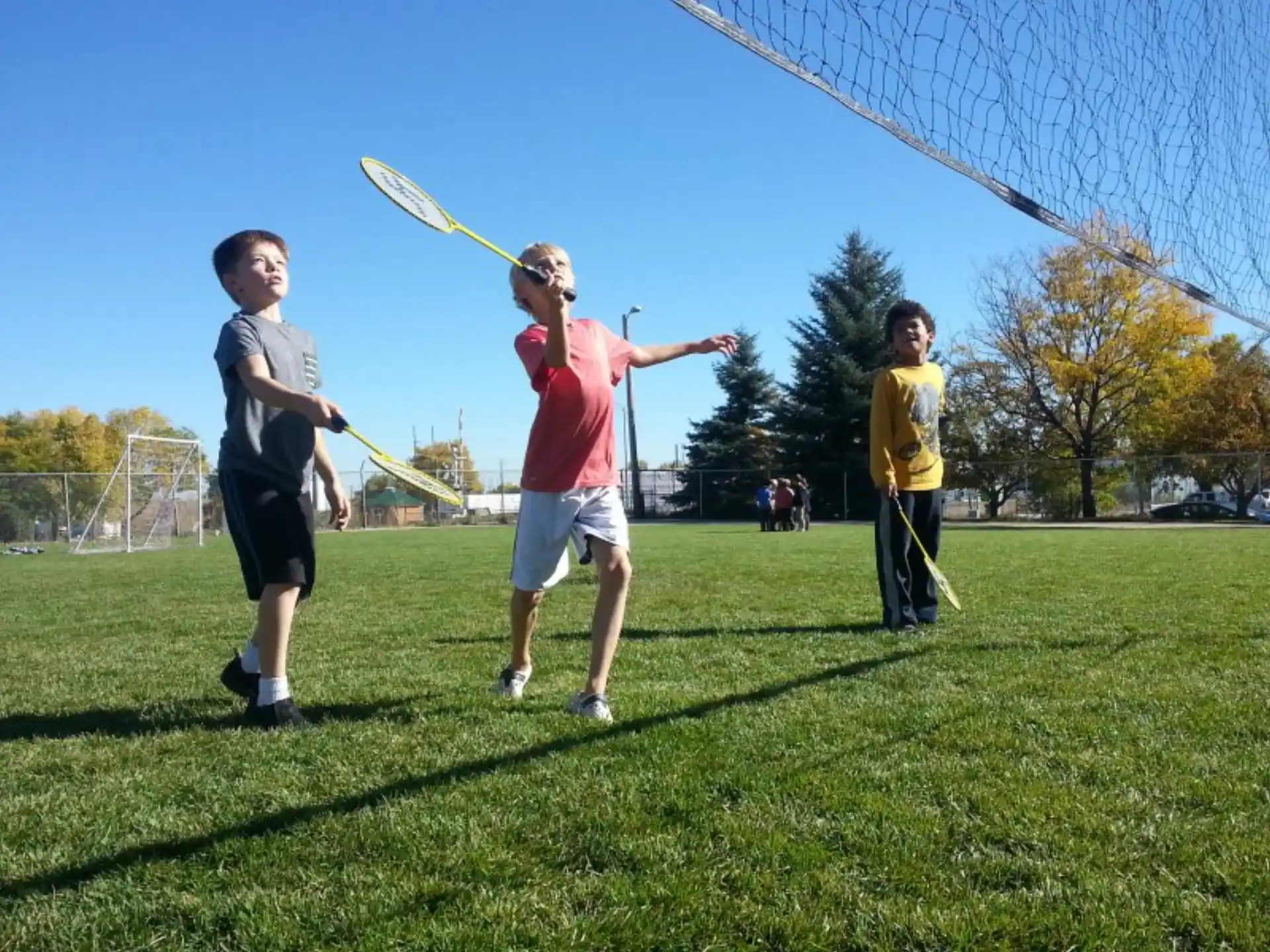 a group of people playing with a kite