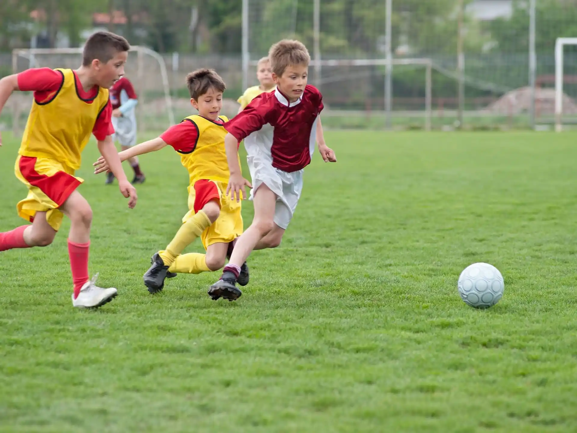 kids playing football on a field