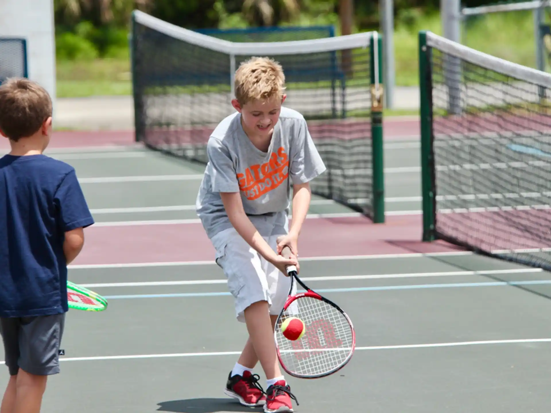 a couple of boys playing tennis