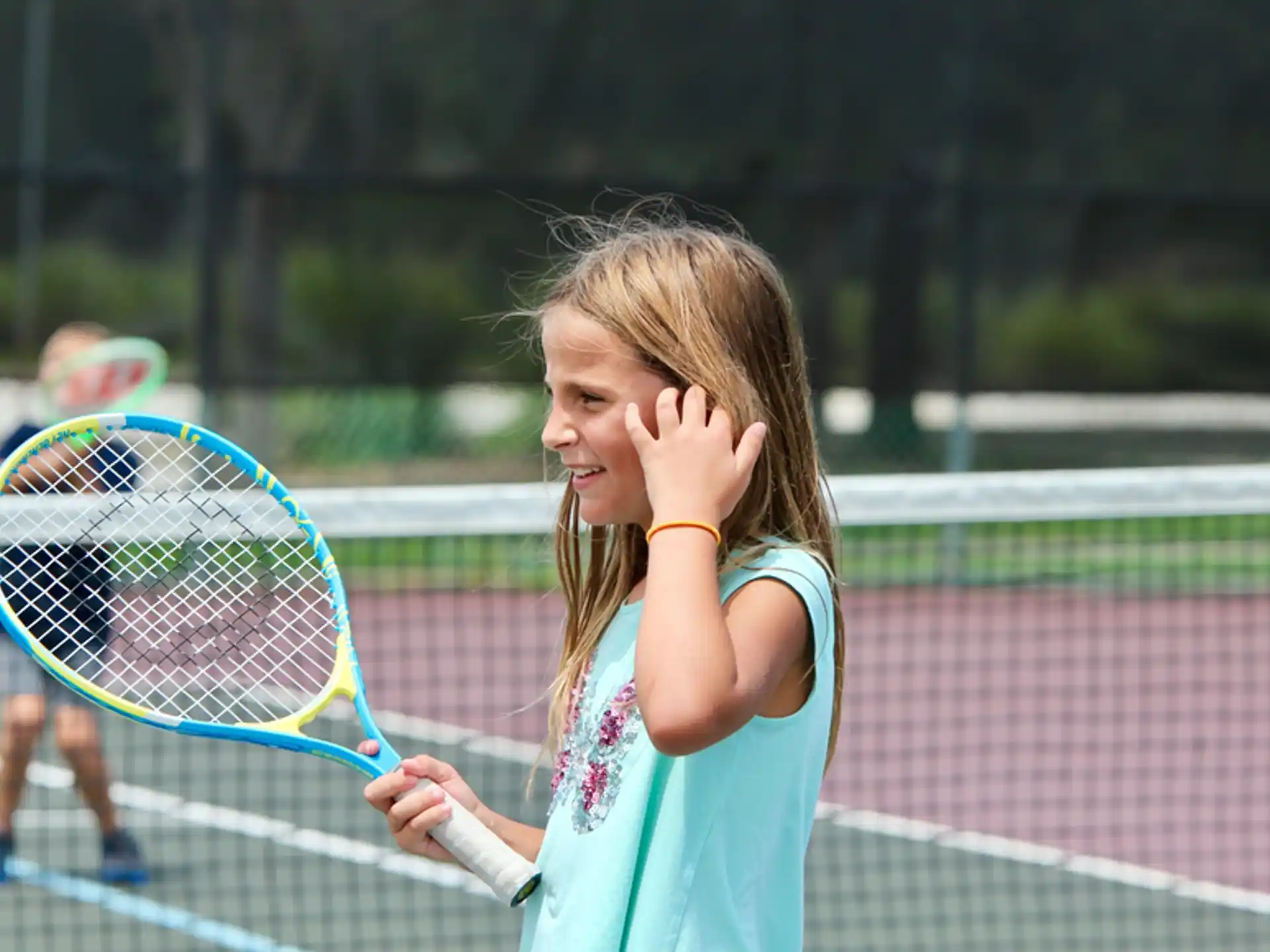 a girl holding a tennis racket