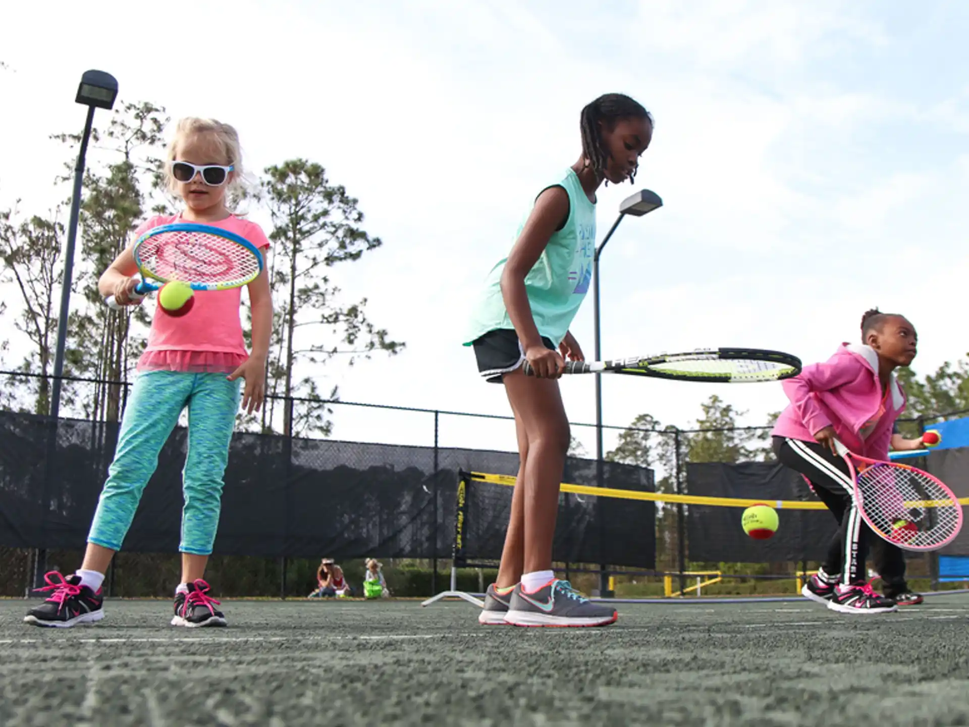 a person and a child playing tennis
