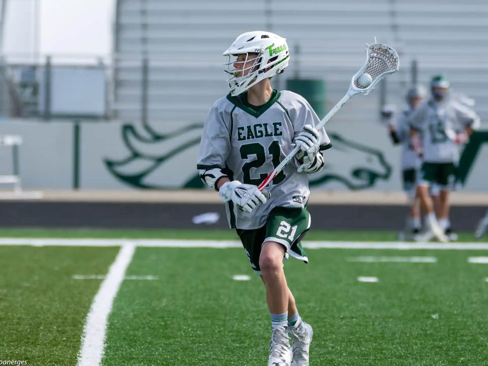 a person wearing a helmet and holding a lacrosse stick