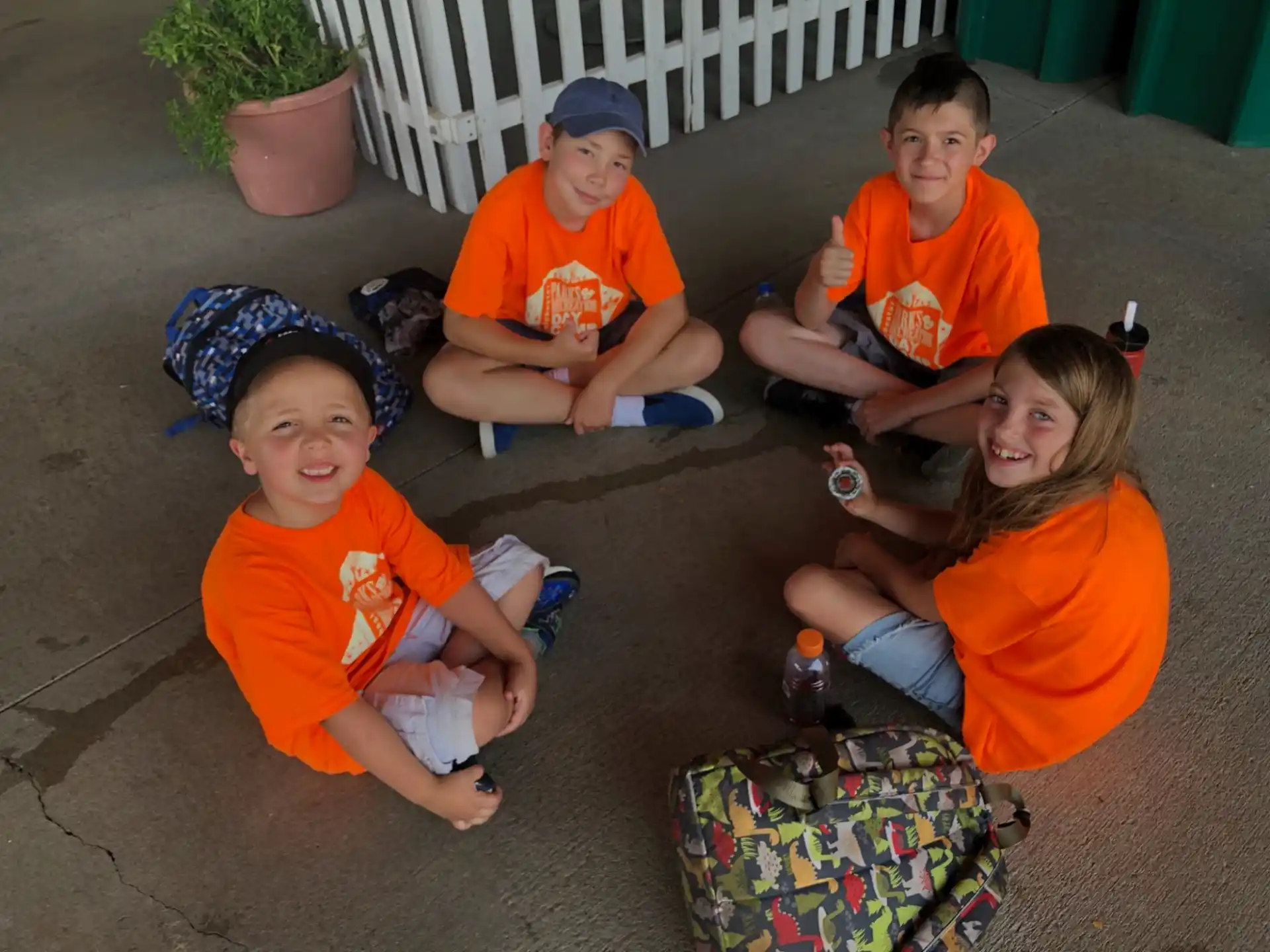 a group of kids sitting on the ground