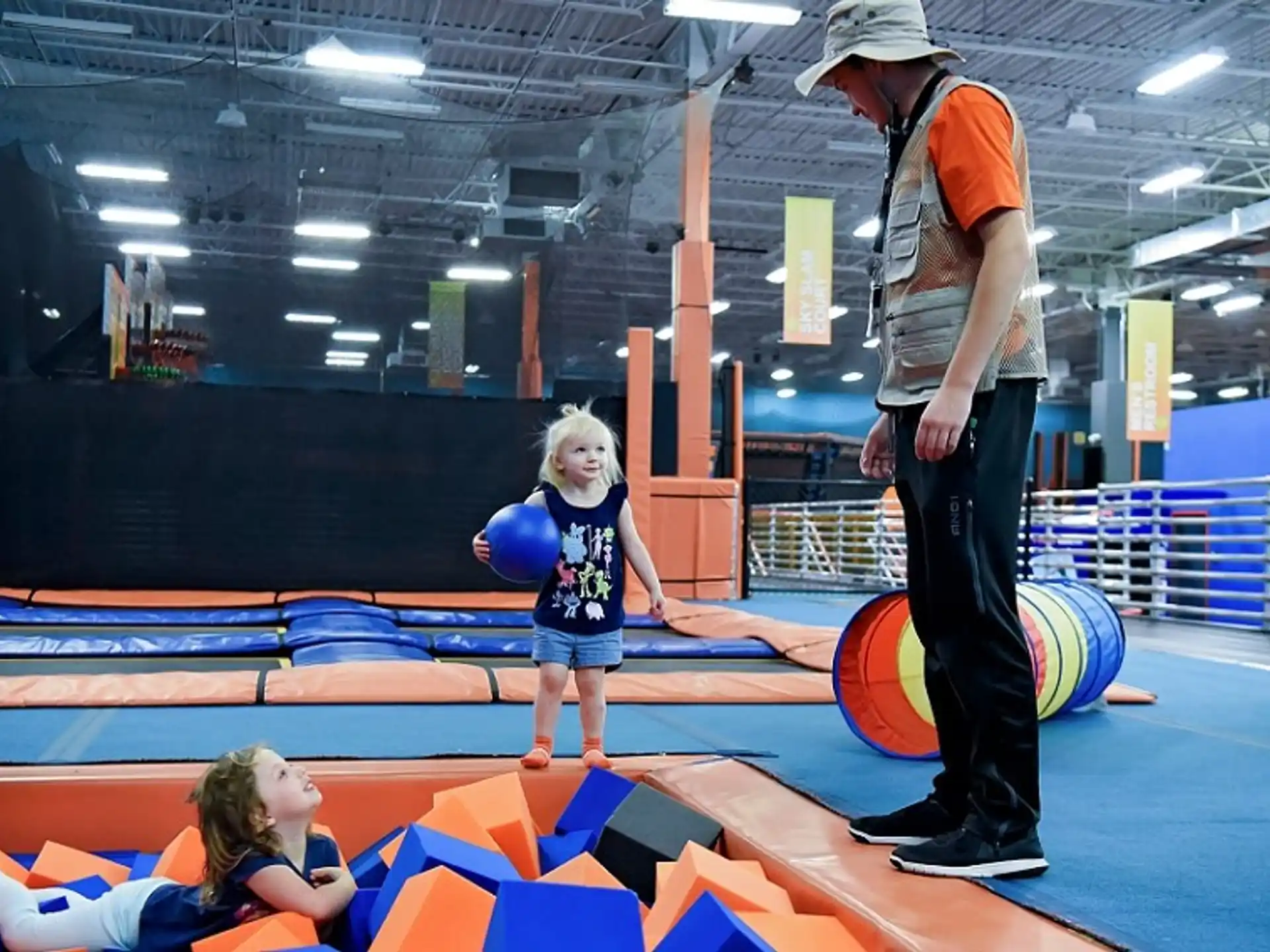a person and a child on a mat in a gym