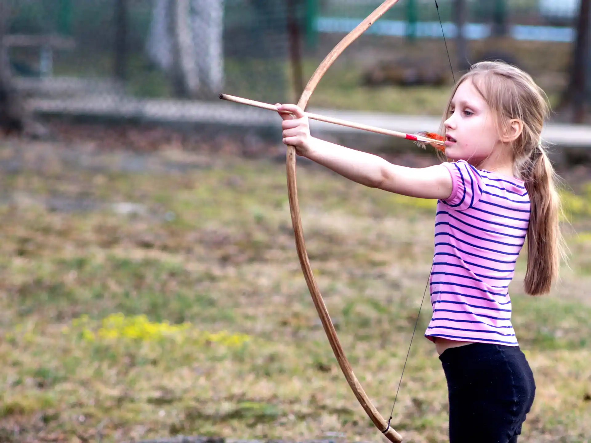 a girl holding a bow and arrow