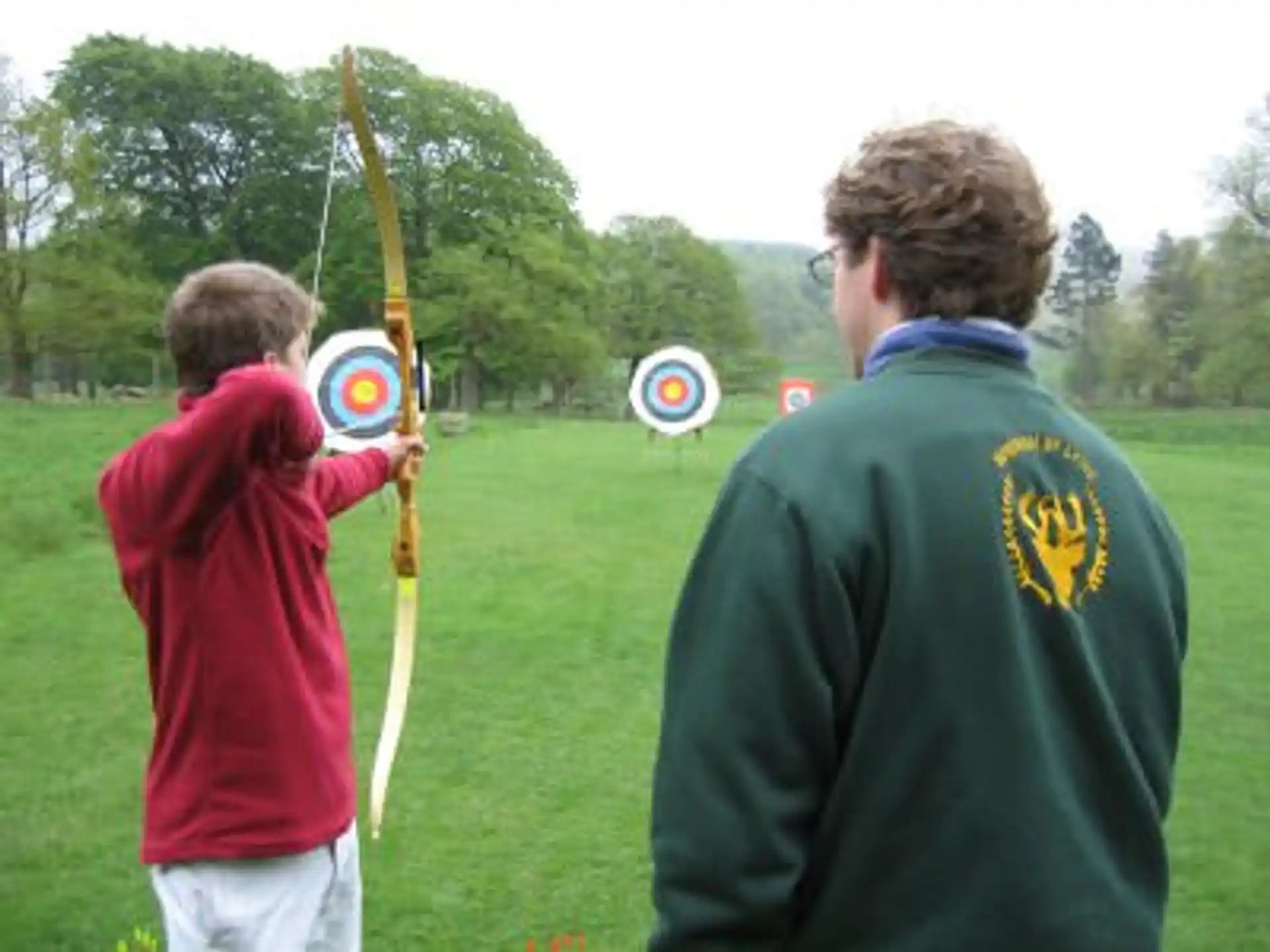 a man and a child holding a bow and arrow