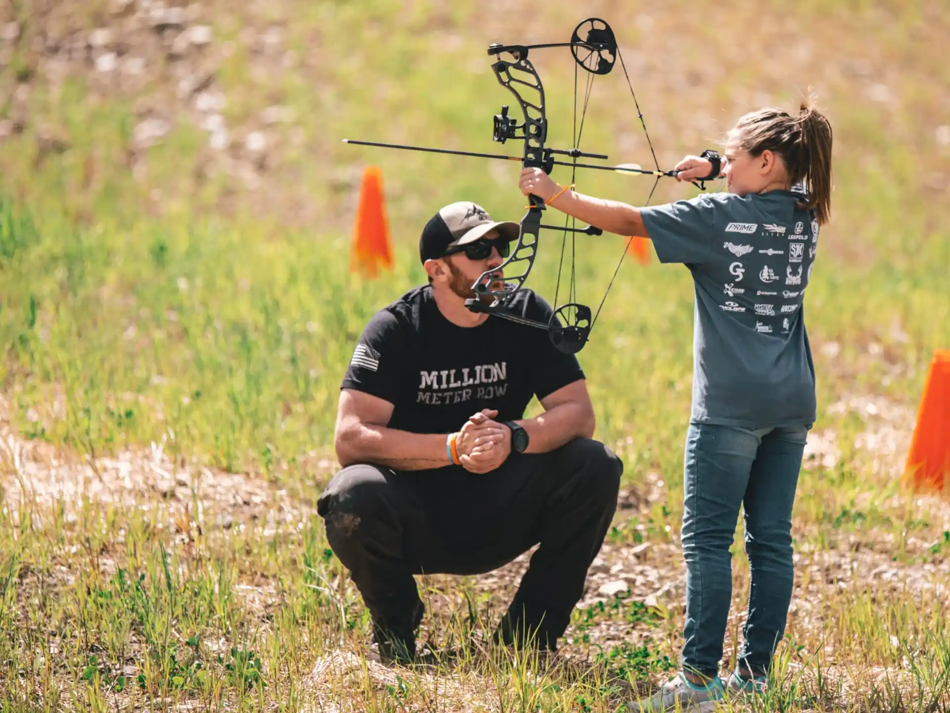 a man shooting a bow and arrow at a woman