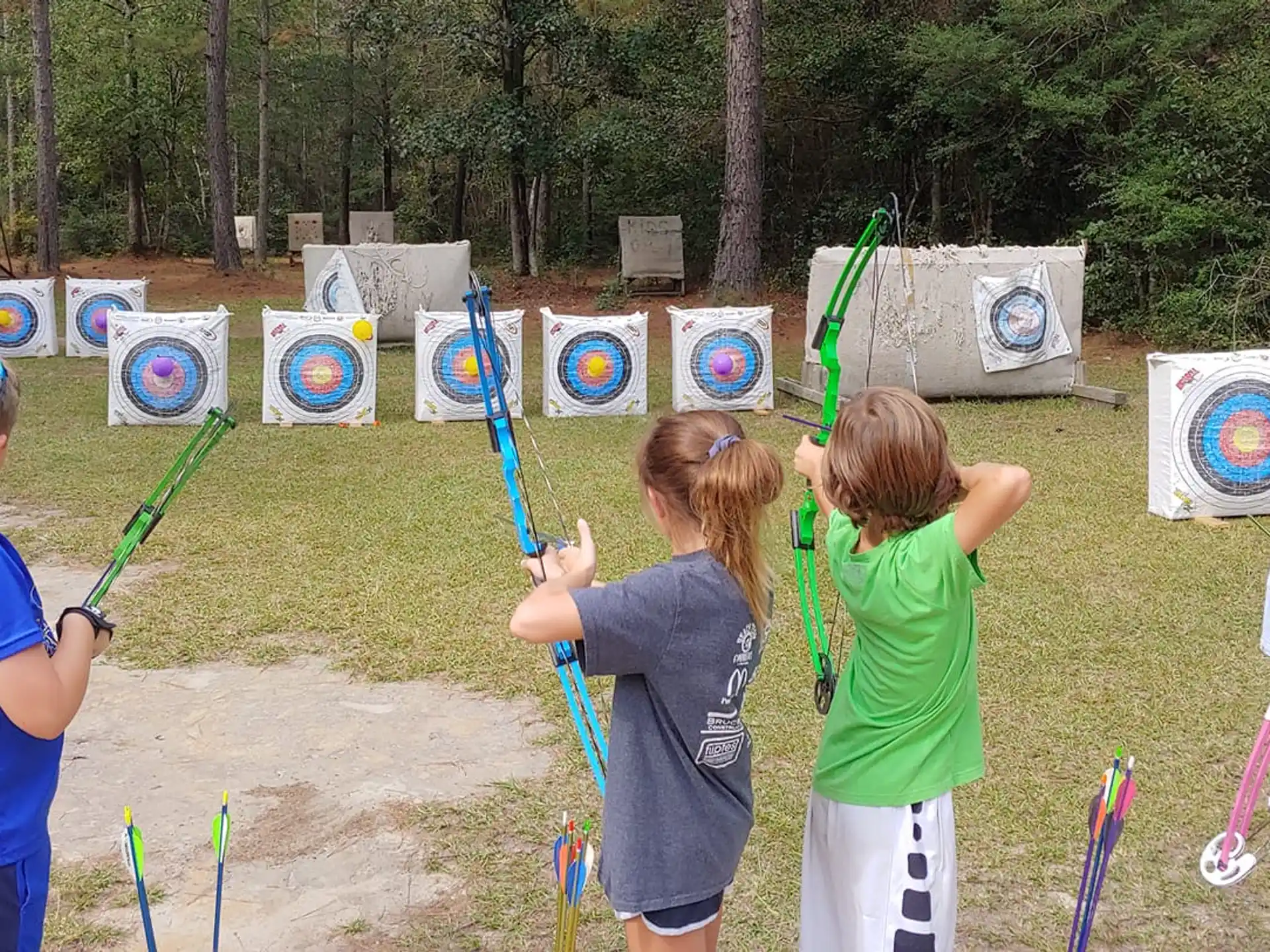 a group of children holding bows and arrows