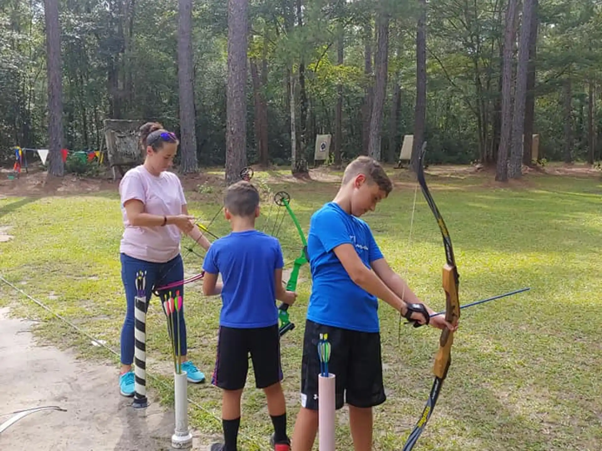 a group of kids holding bows and arrows