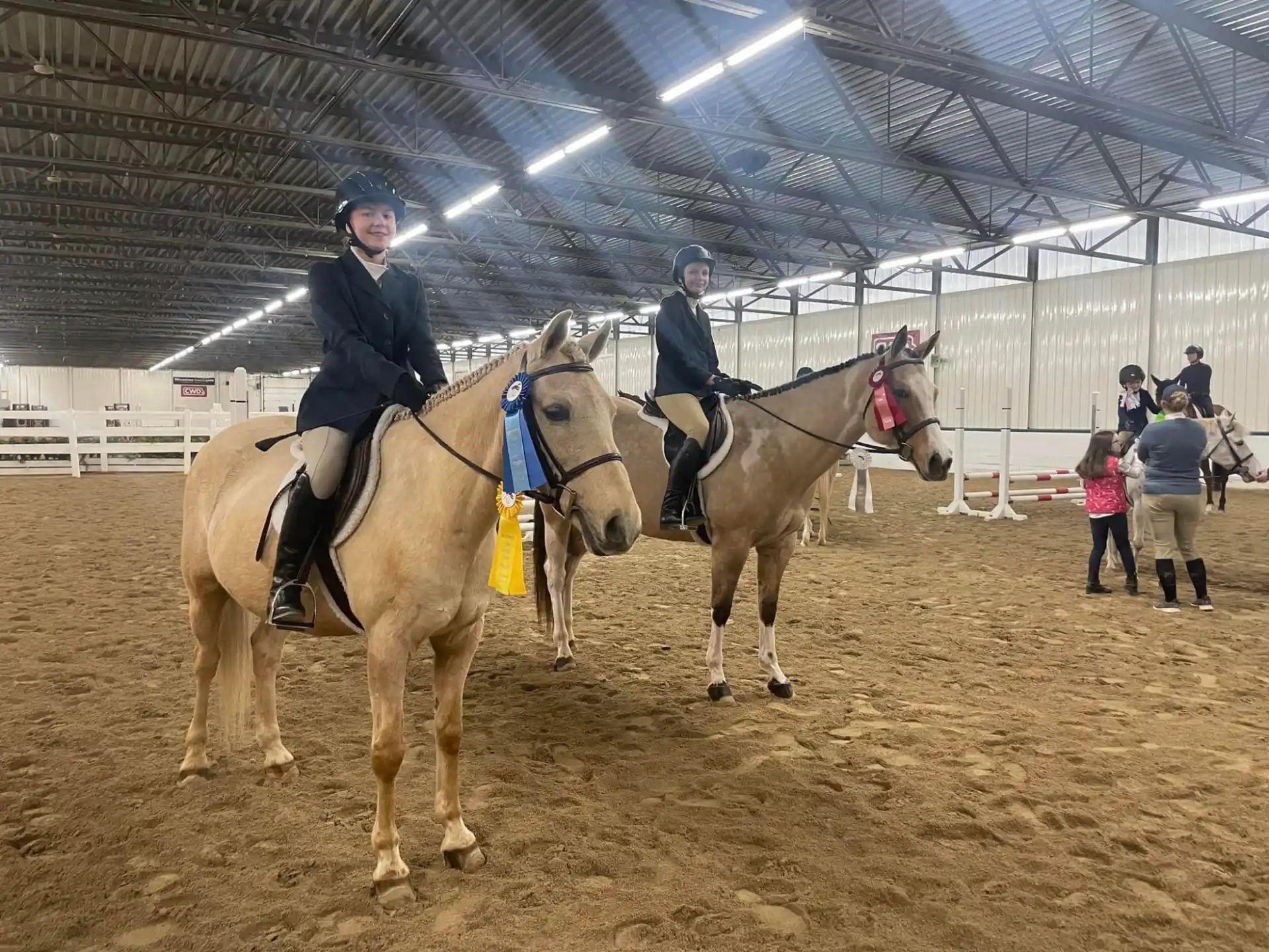 a couple of people riding horses