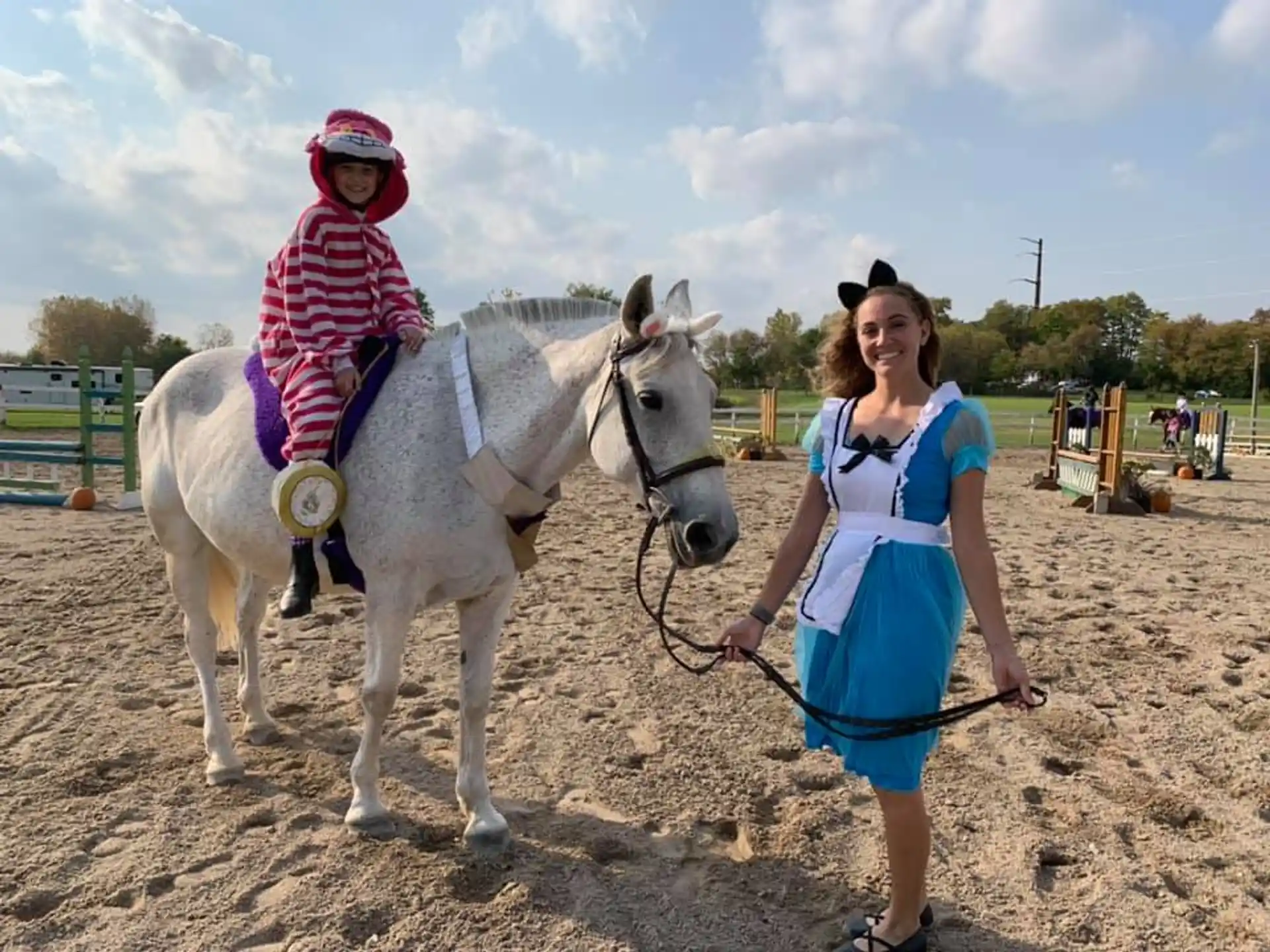 a man walking a horse with a child on it