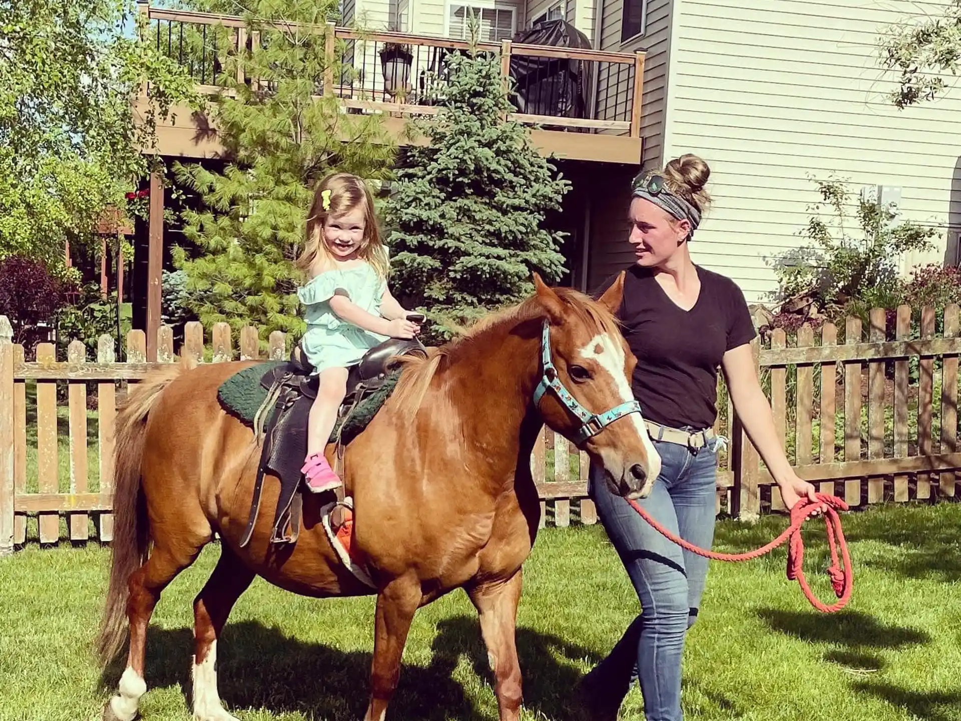 a person and a child riding a horse