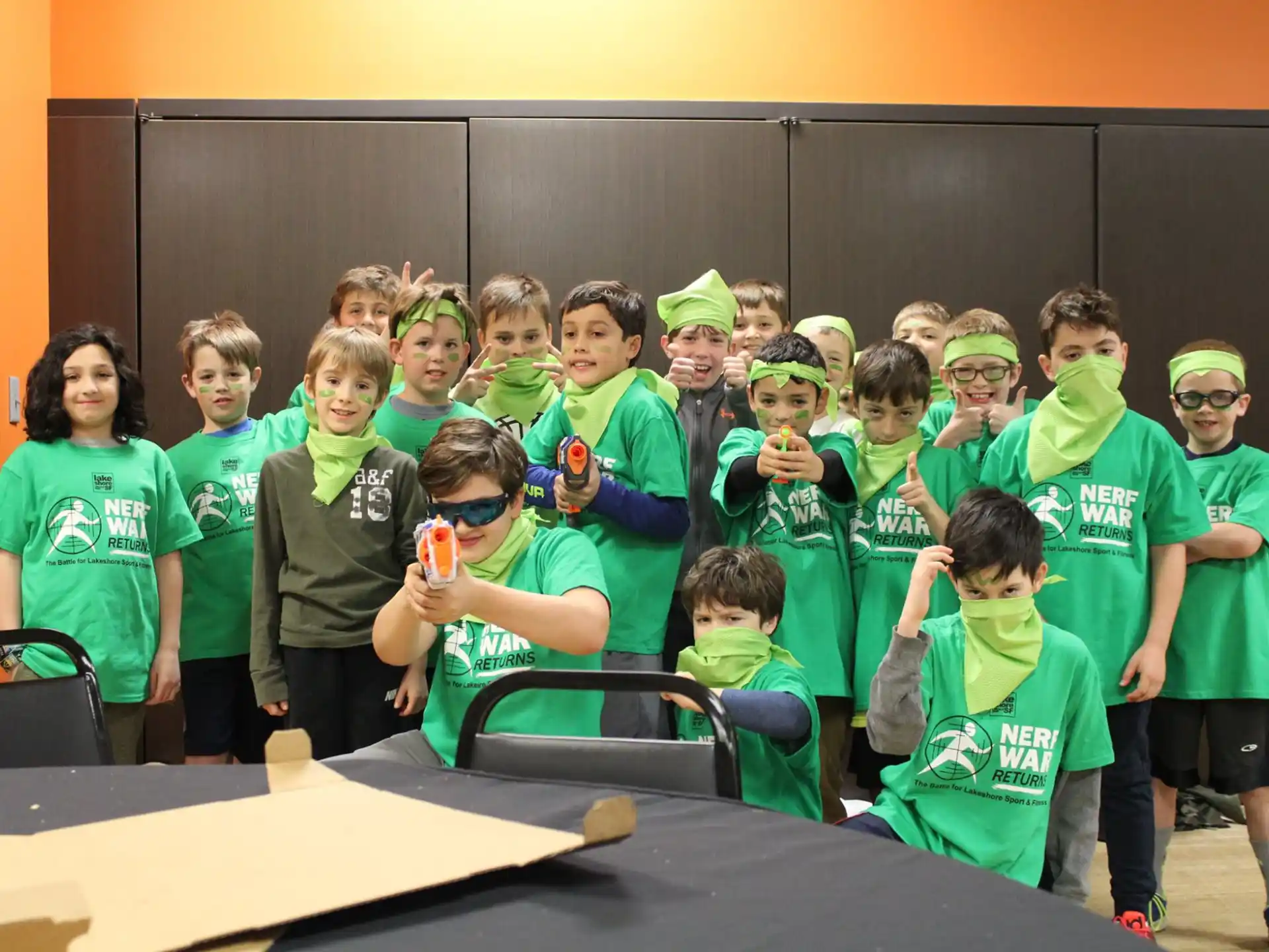 a group of people wearing green shirts