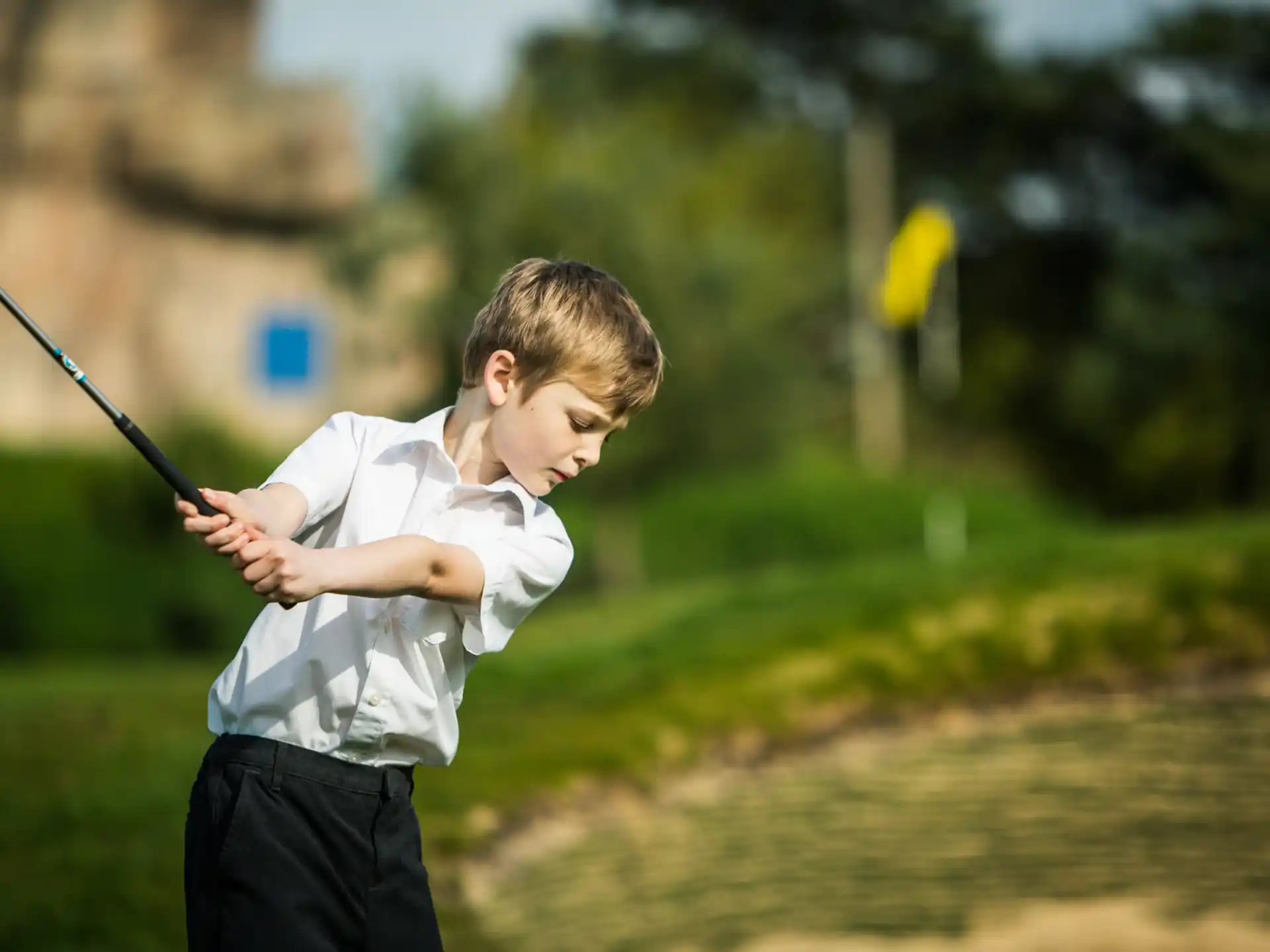 a boy swinging a bat