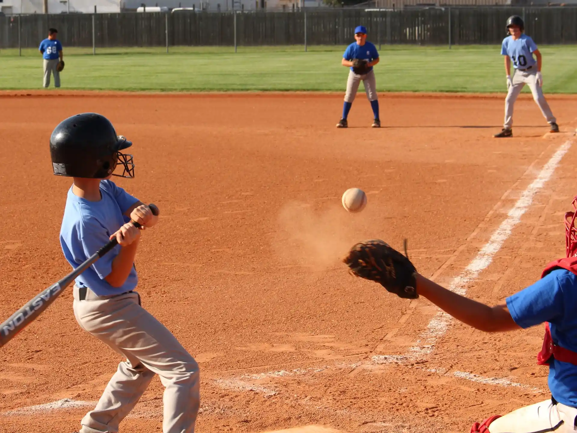 a baseball player hitting a ball with a bat