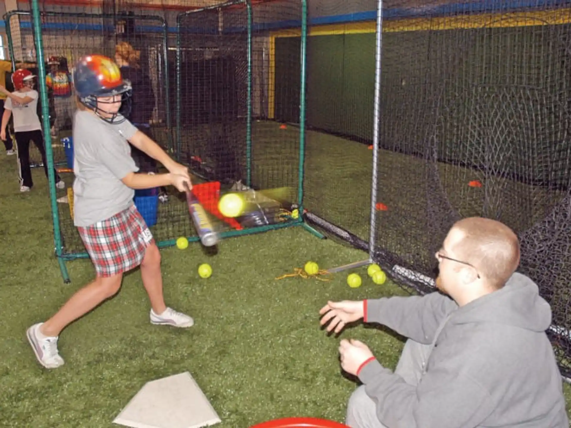 a kid swings a baseball bat
