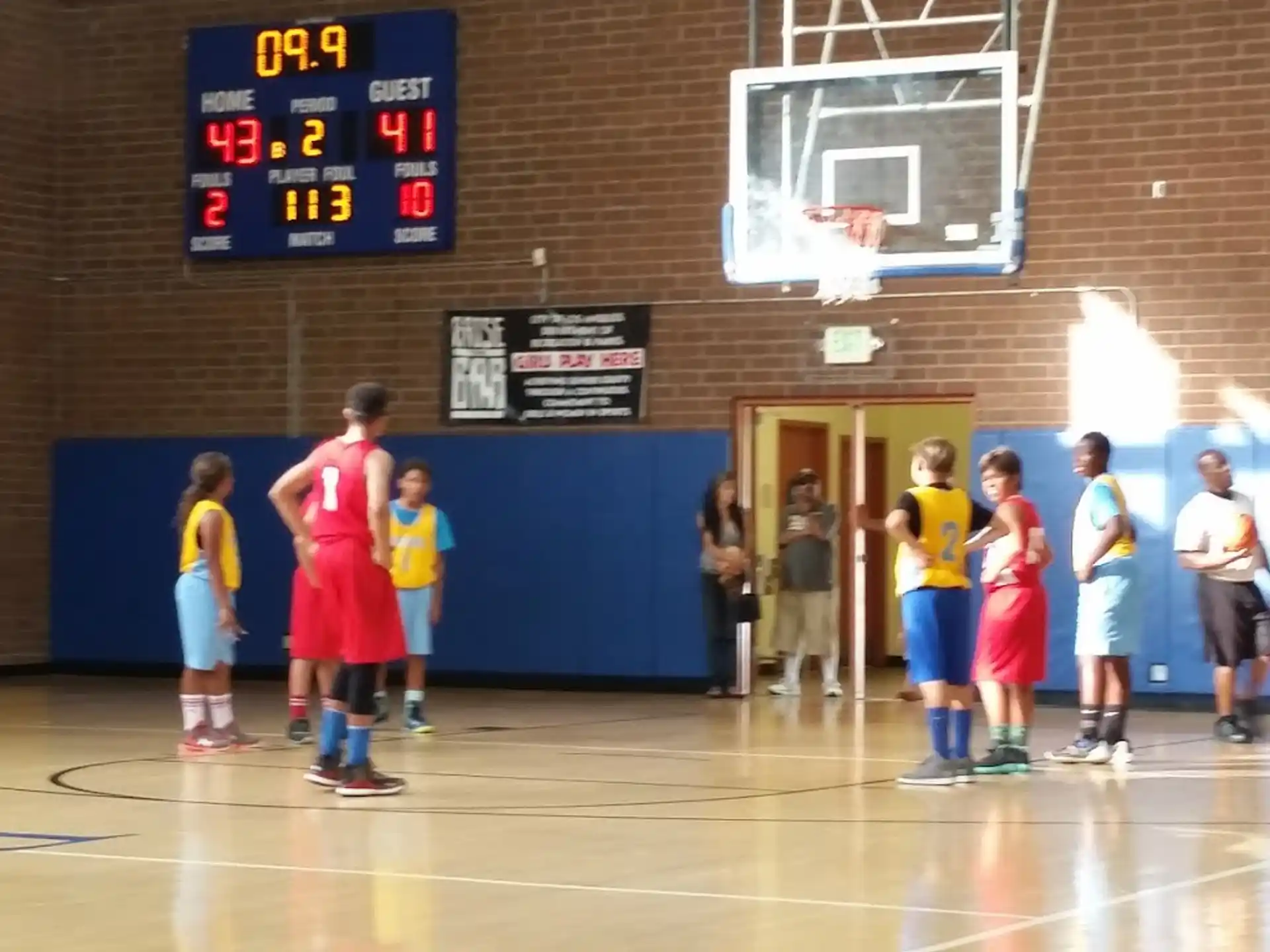 a group of kids playing basketball