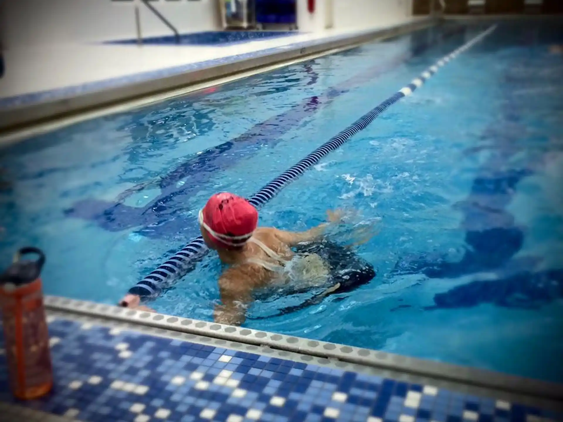 a person in a pool with a ball in their hand