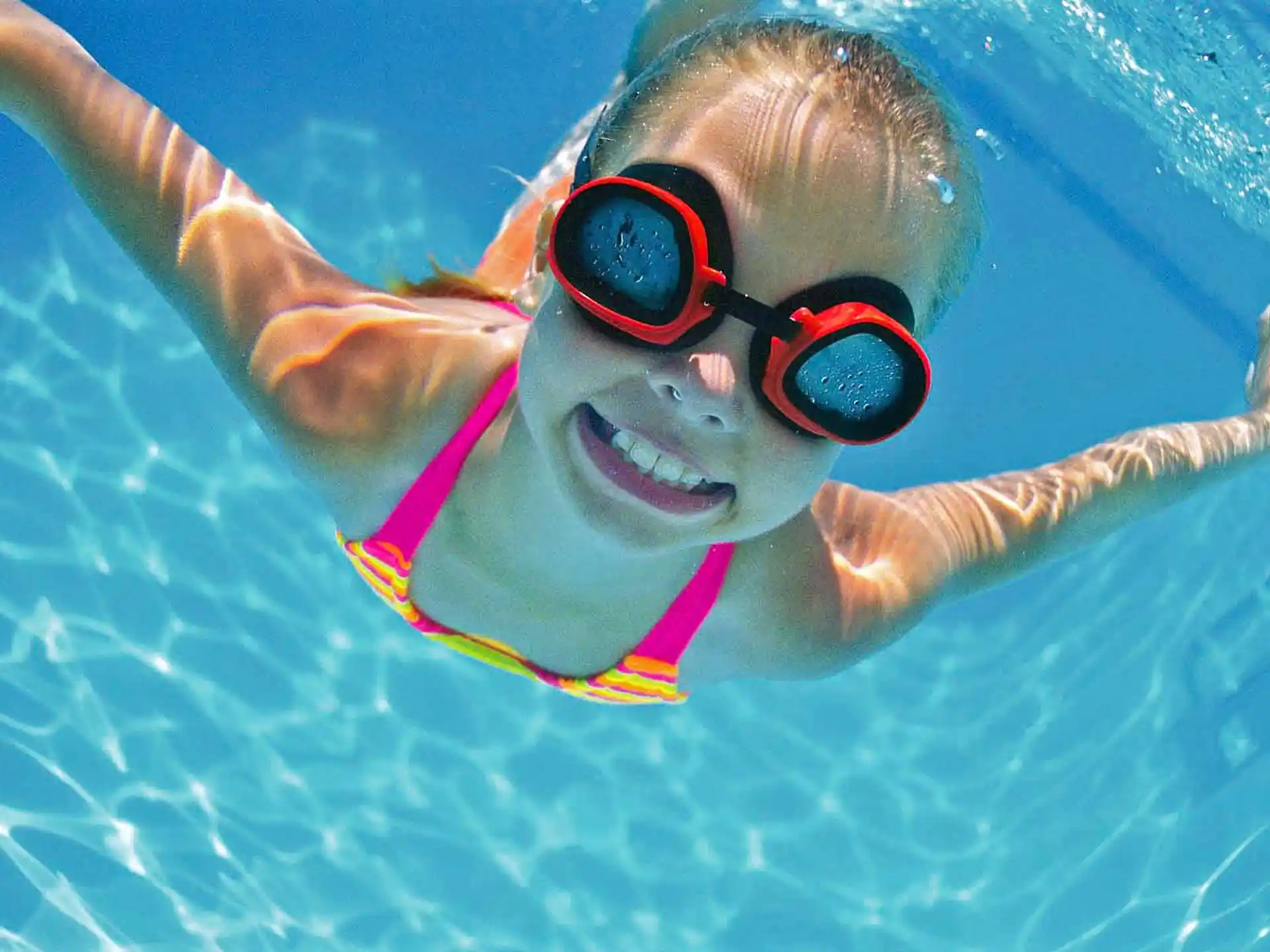 a person wearing goggles and swimming