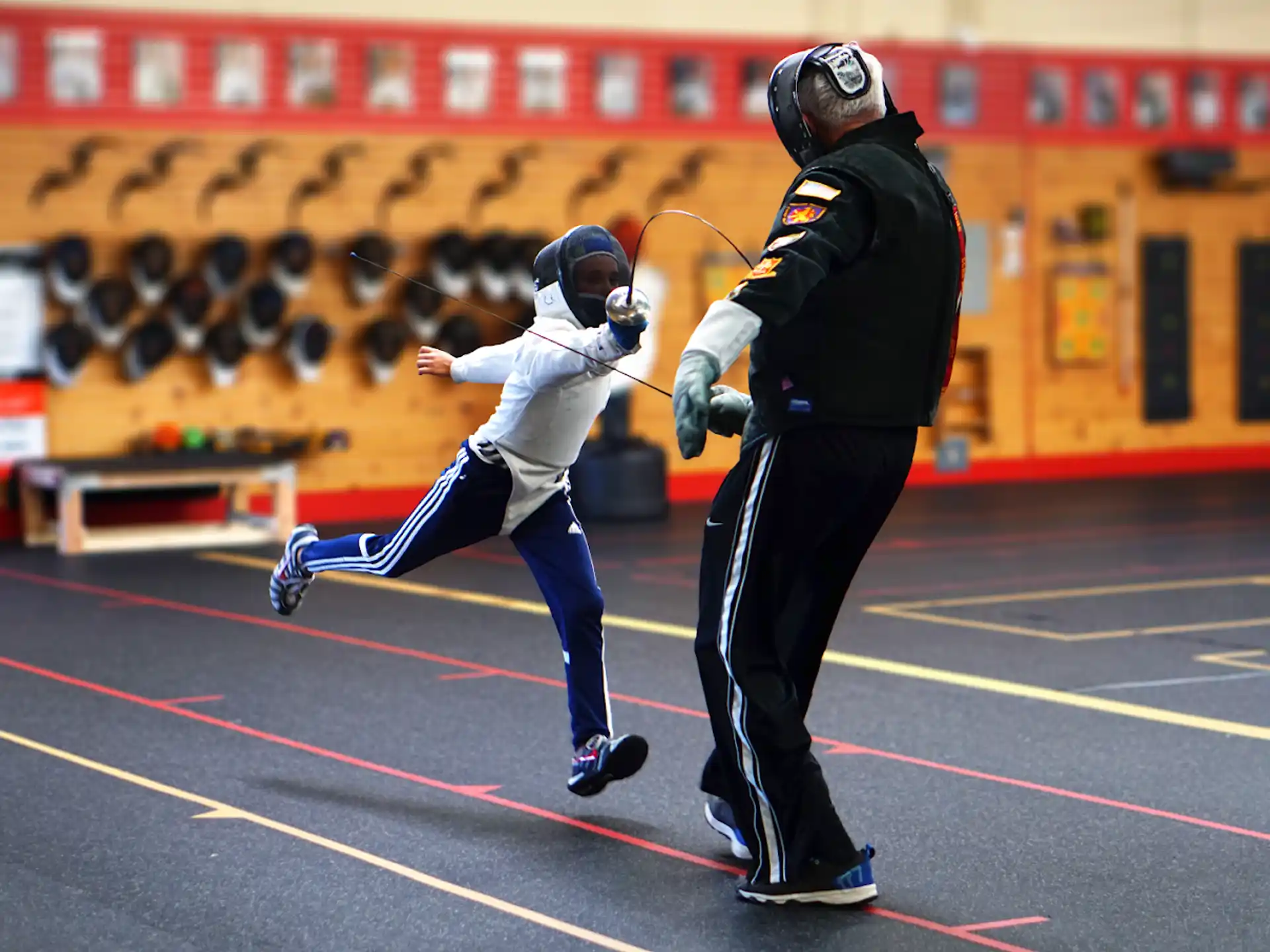 a person in a uniform running with a person in a mask