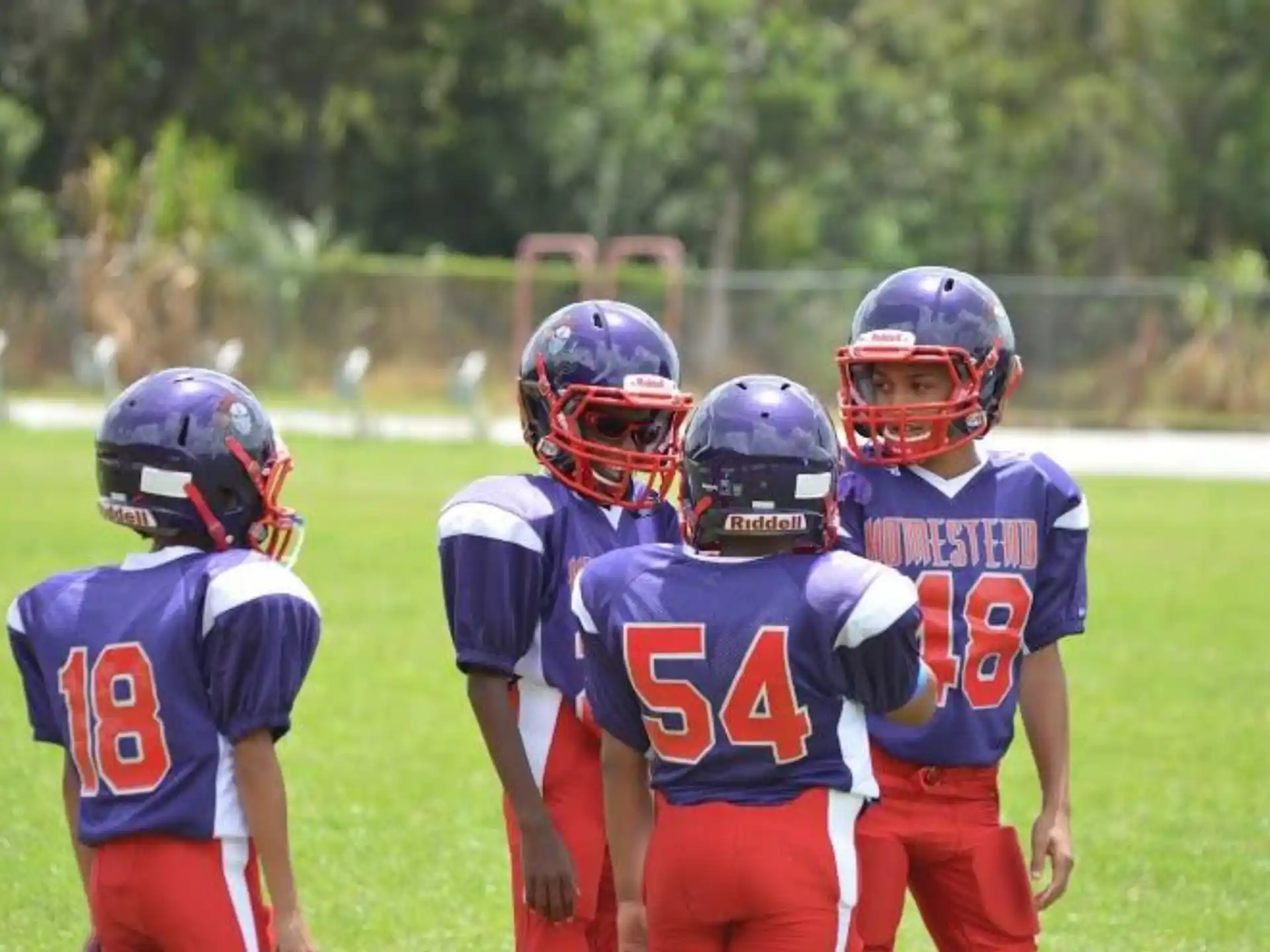 a group of kids wearing football gear