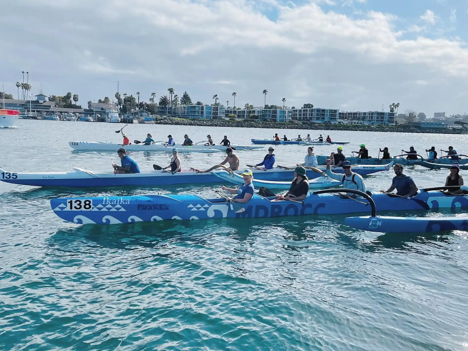 a group of people in boats on water