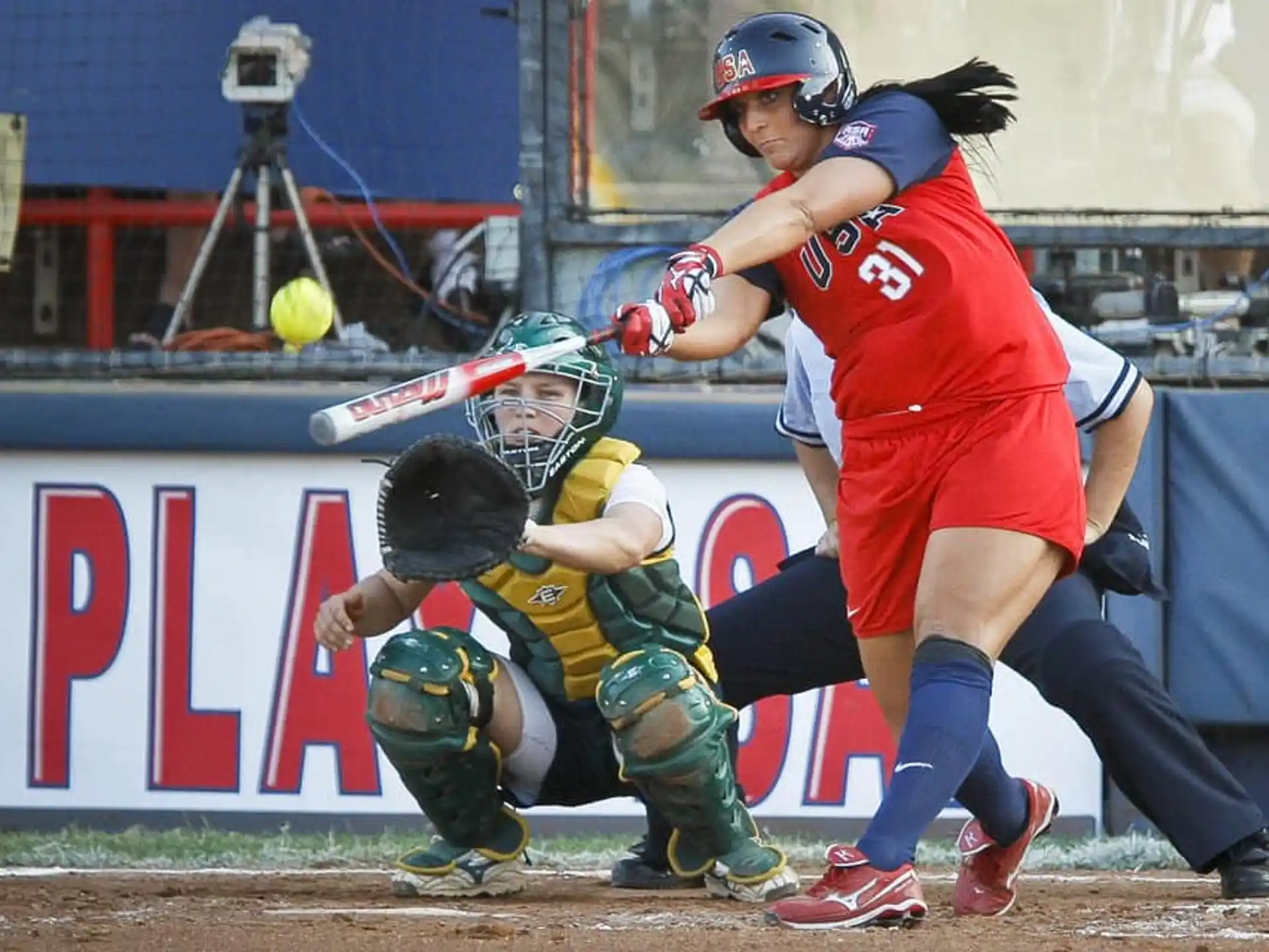 a person hitting a ball with a baseball bat