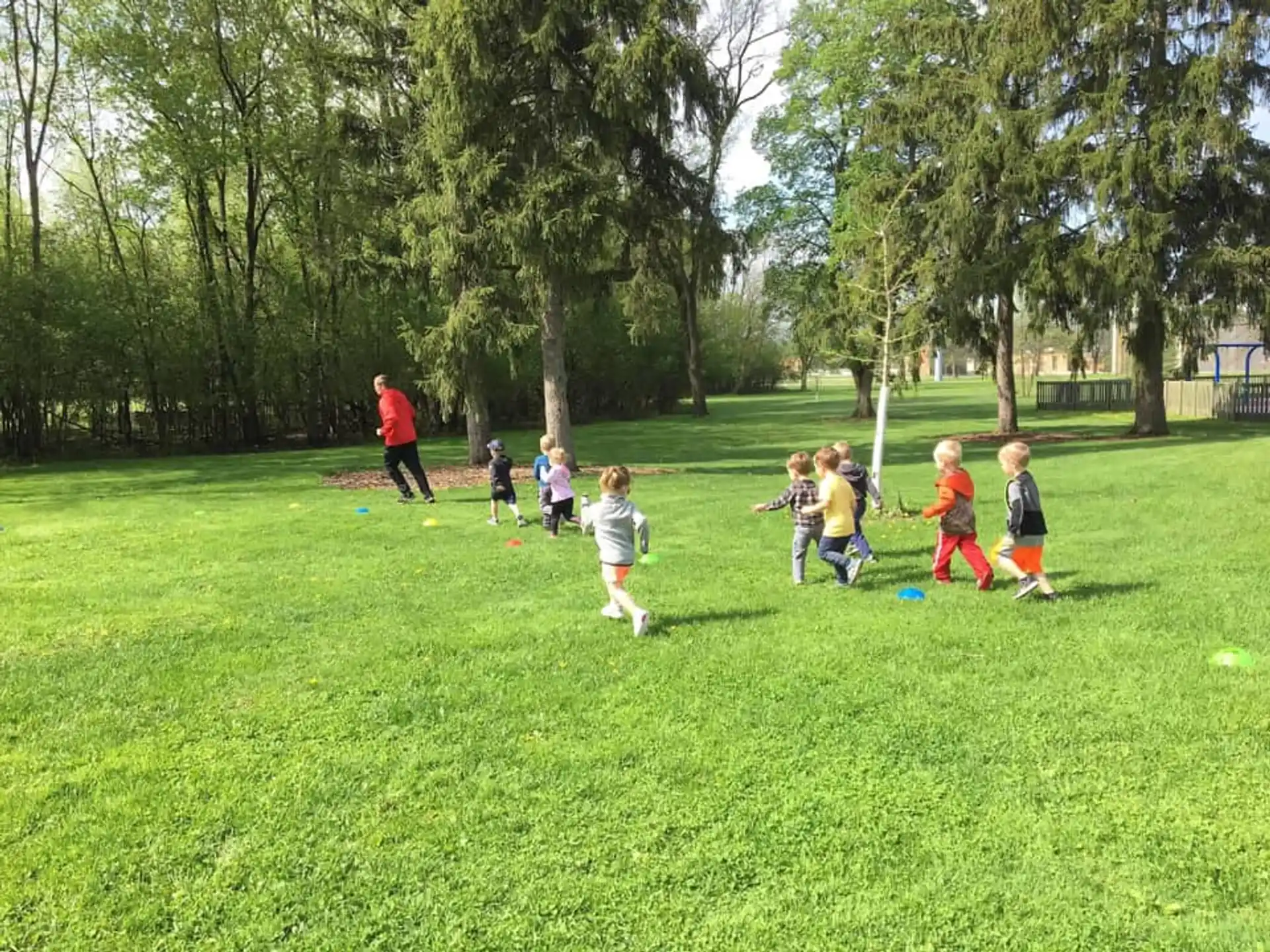 a group of kids playing in a grassy field