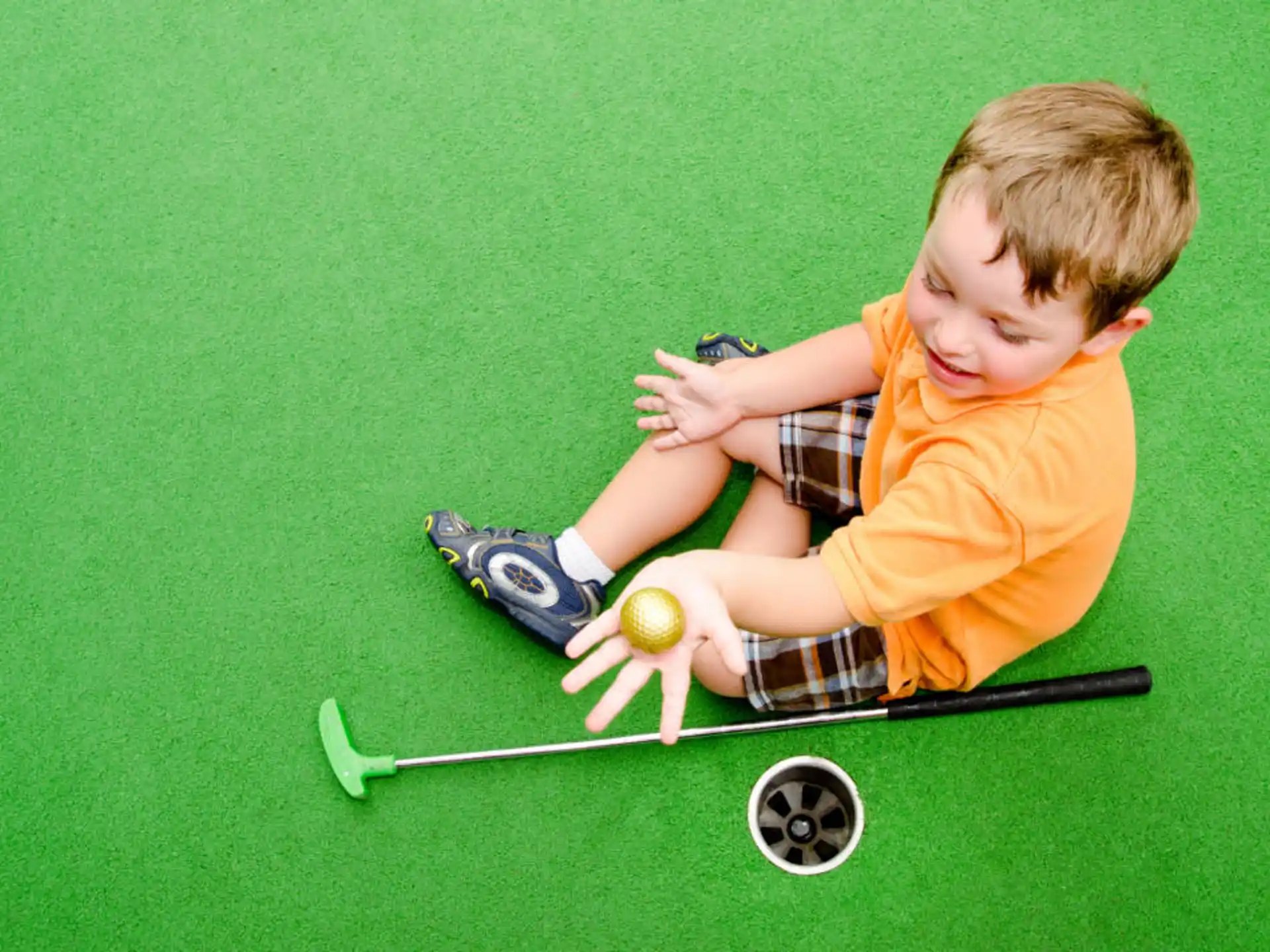 a boy playing golf