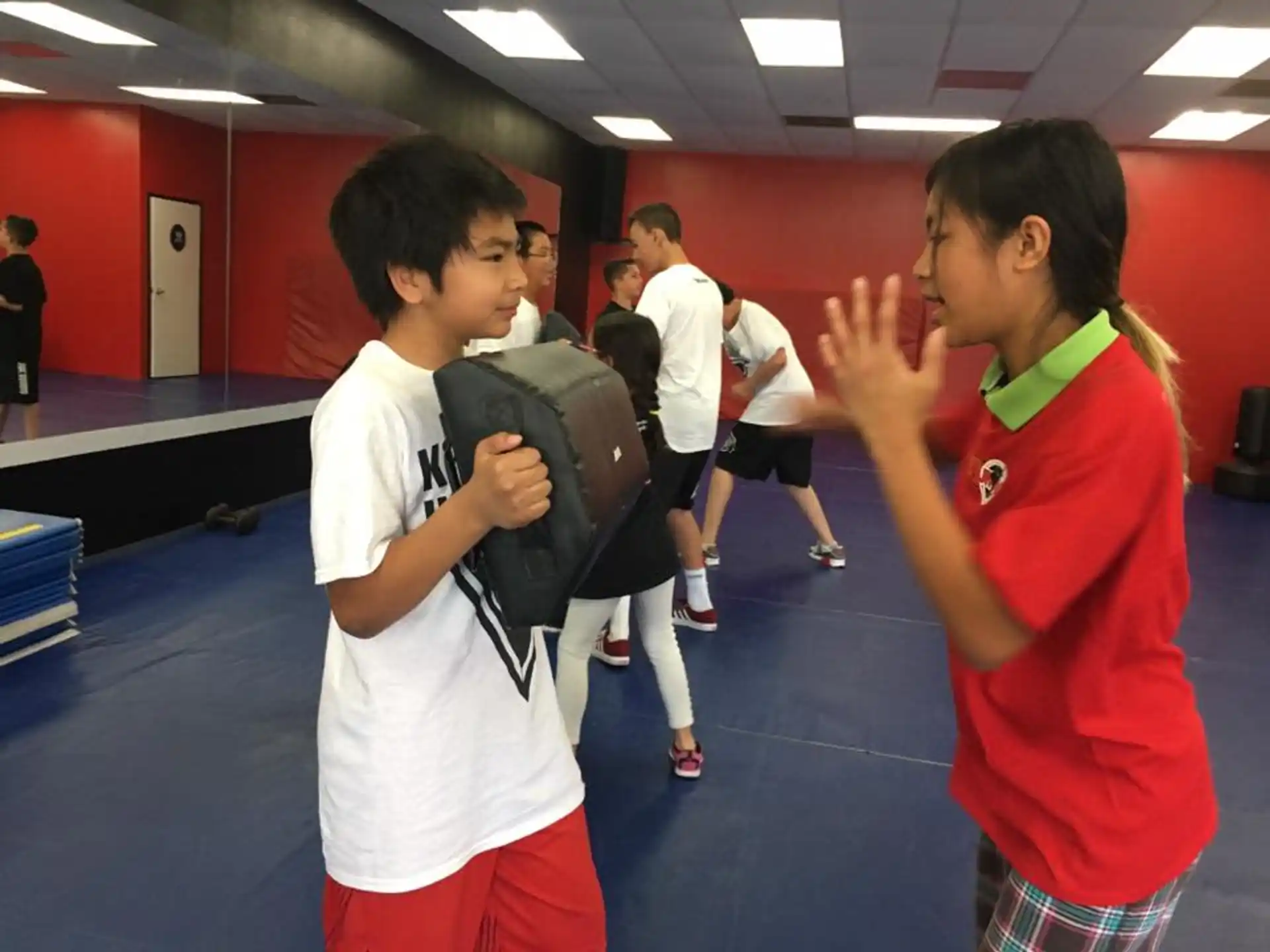 a person and a boy in a gym