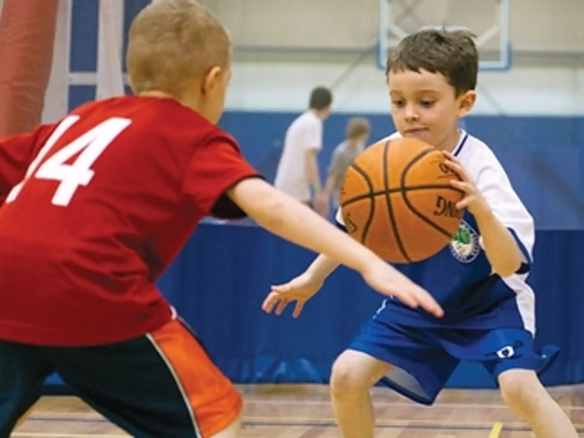 a couple of boys playing basketball