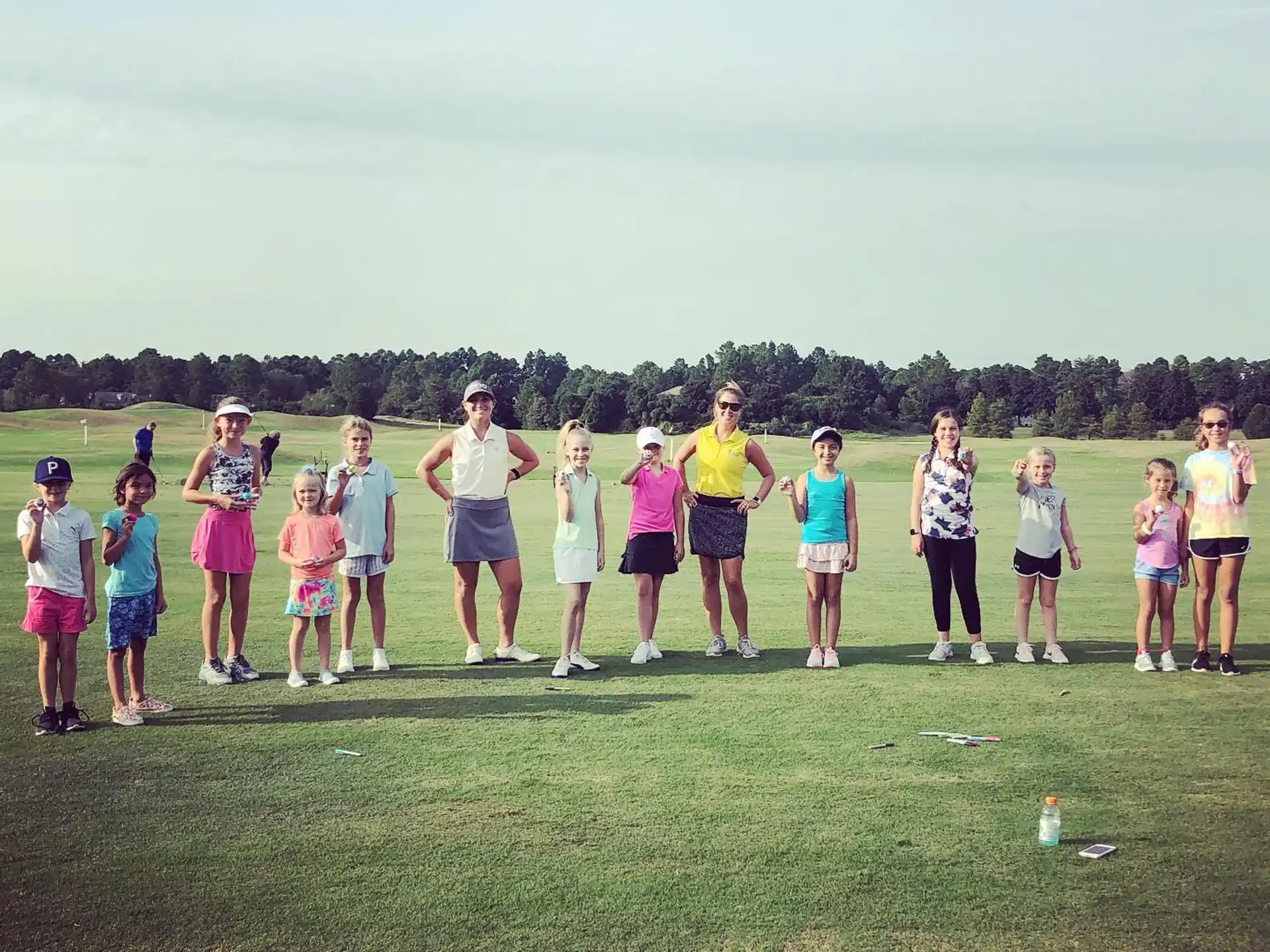 a group of people standing on a grass field