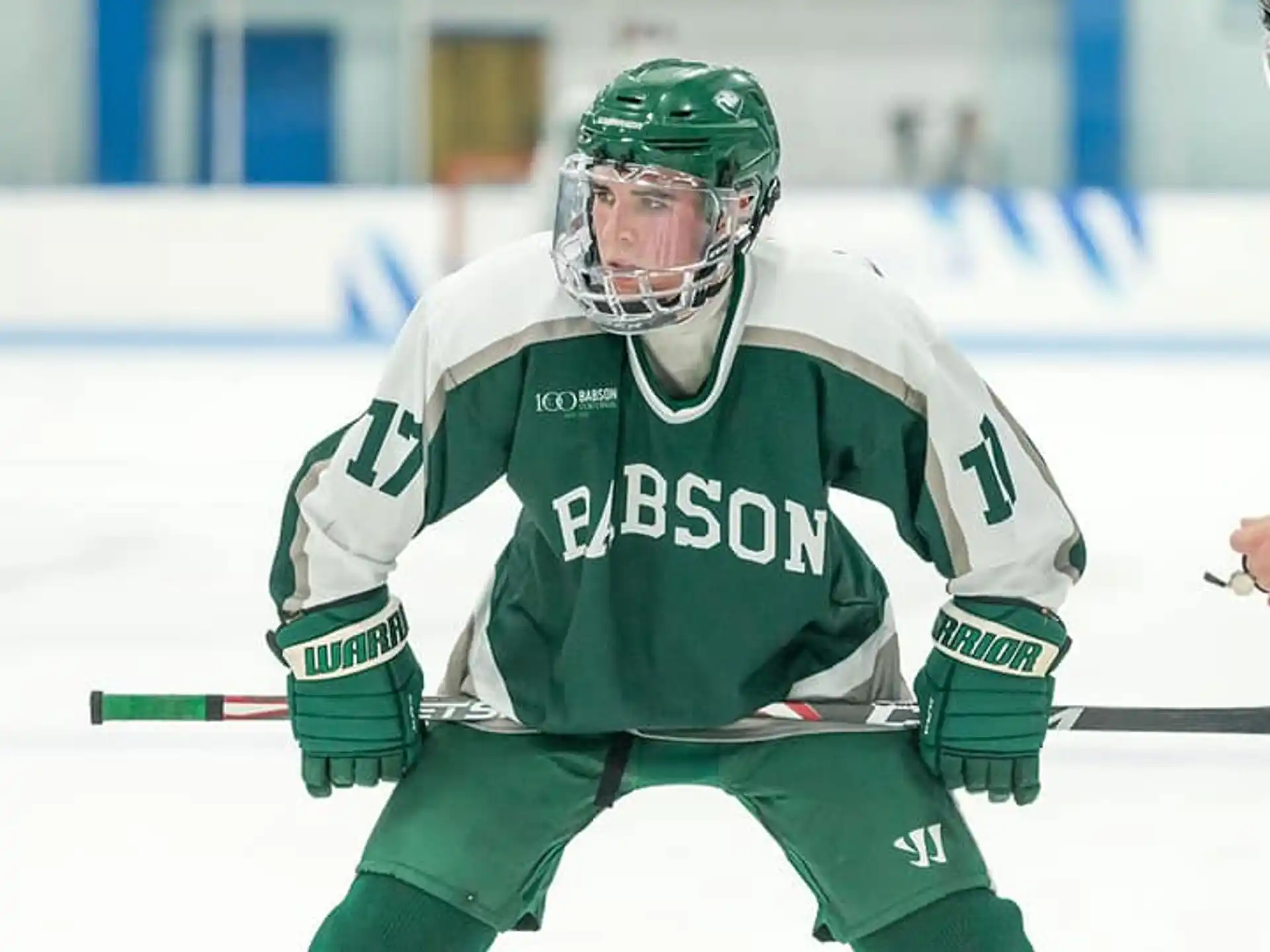 a hockey player in a green uniform
