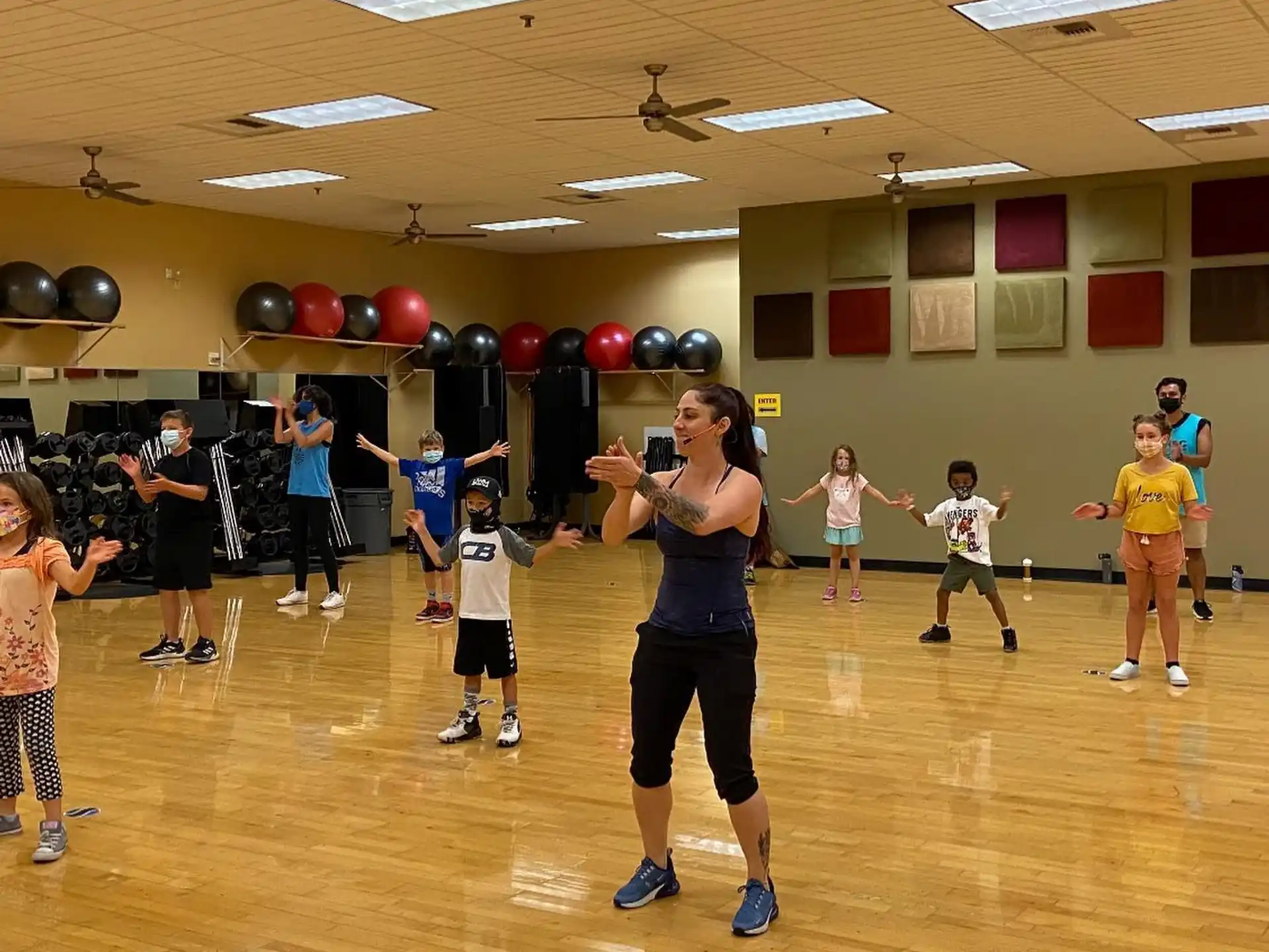 a group of people exercising in a gym