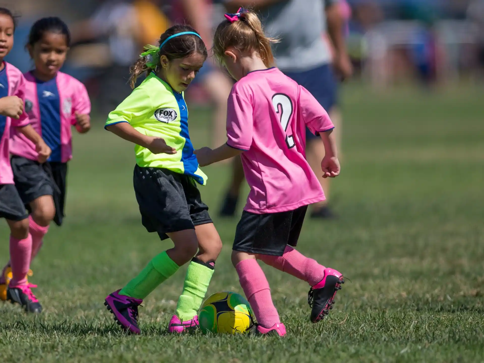 girls playing football on a field