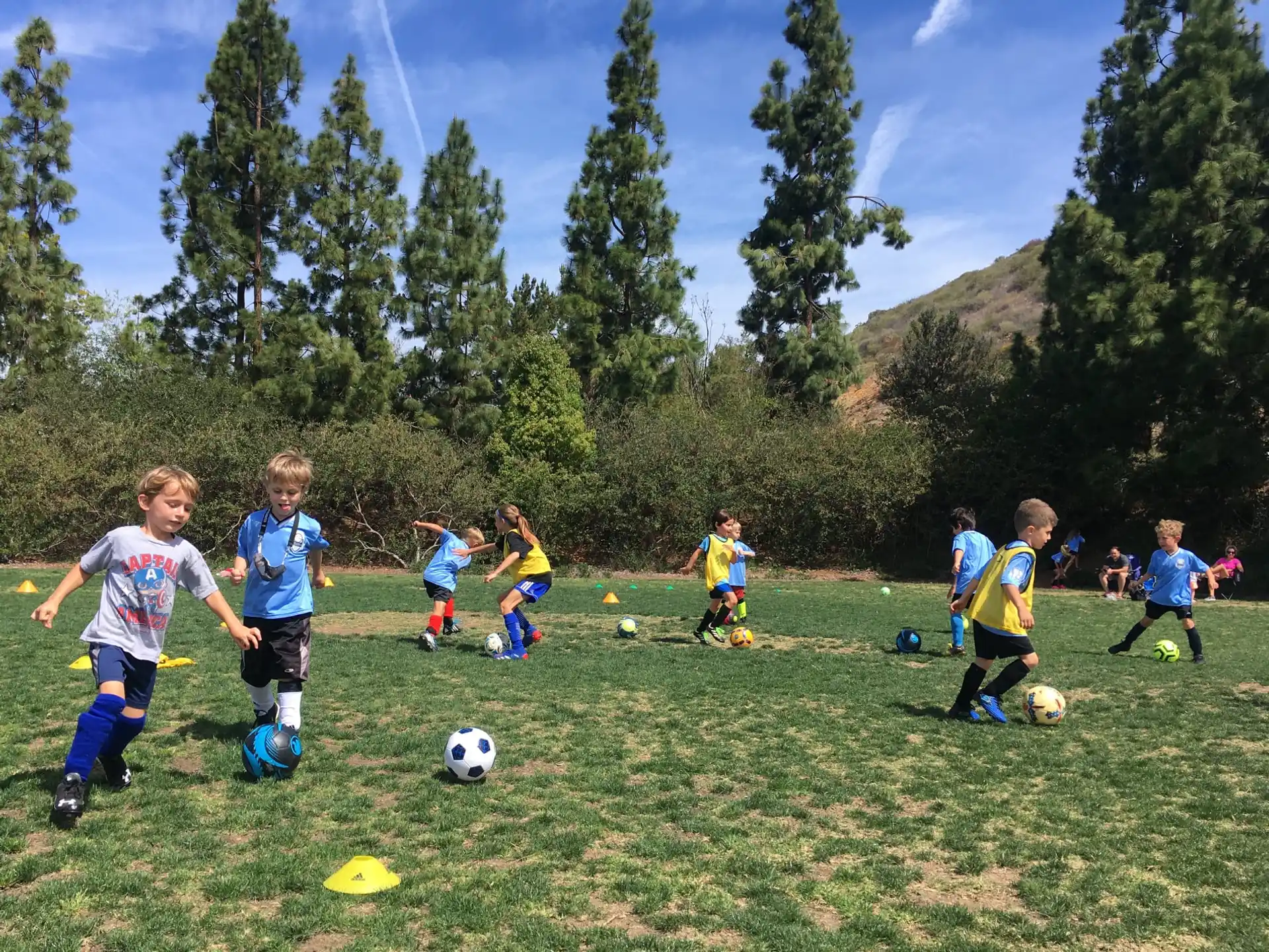 kids playing football in the grass
