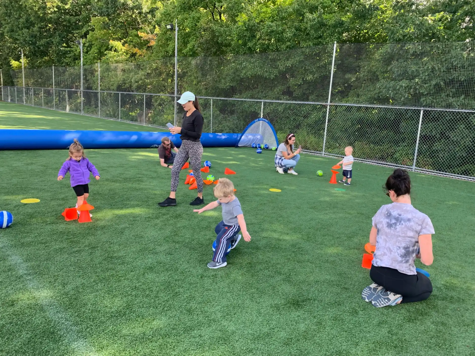 a group of people playing in a grassy field