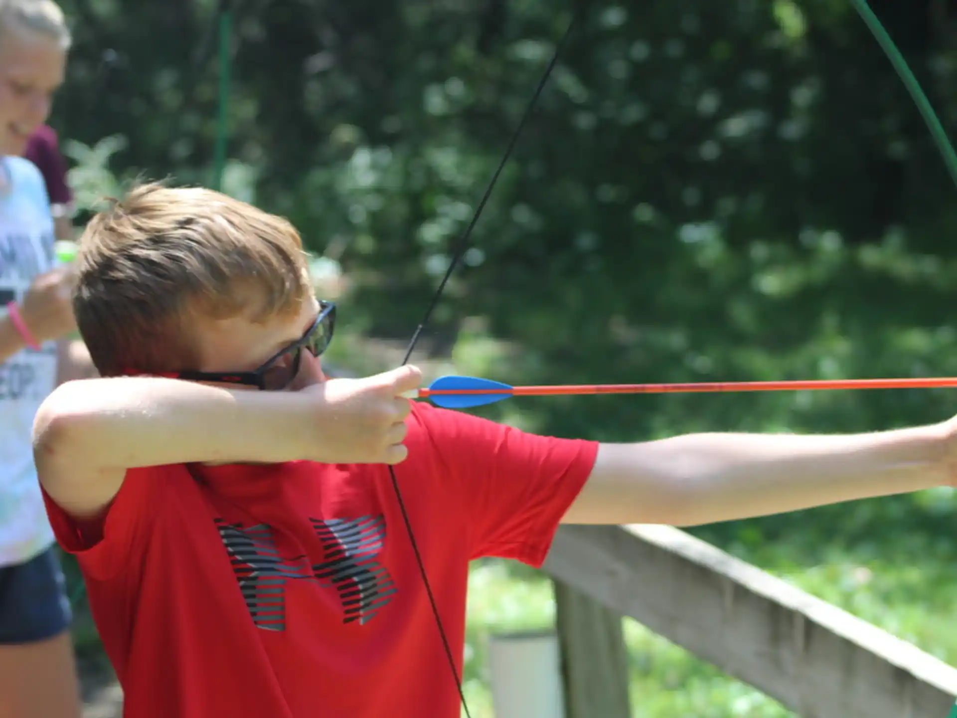 a boy holding a bow and arrow