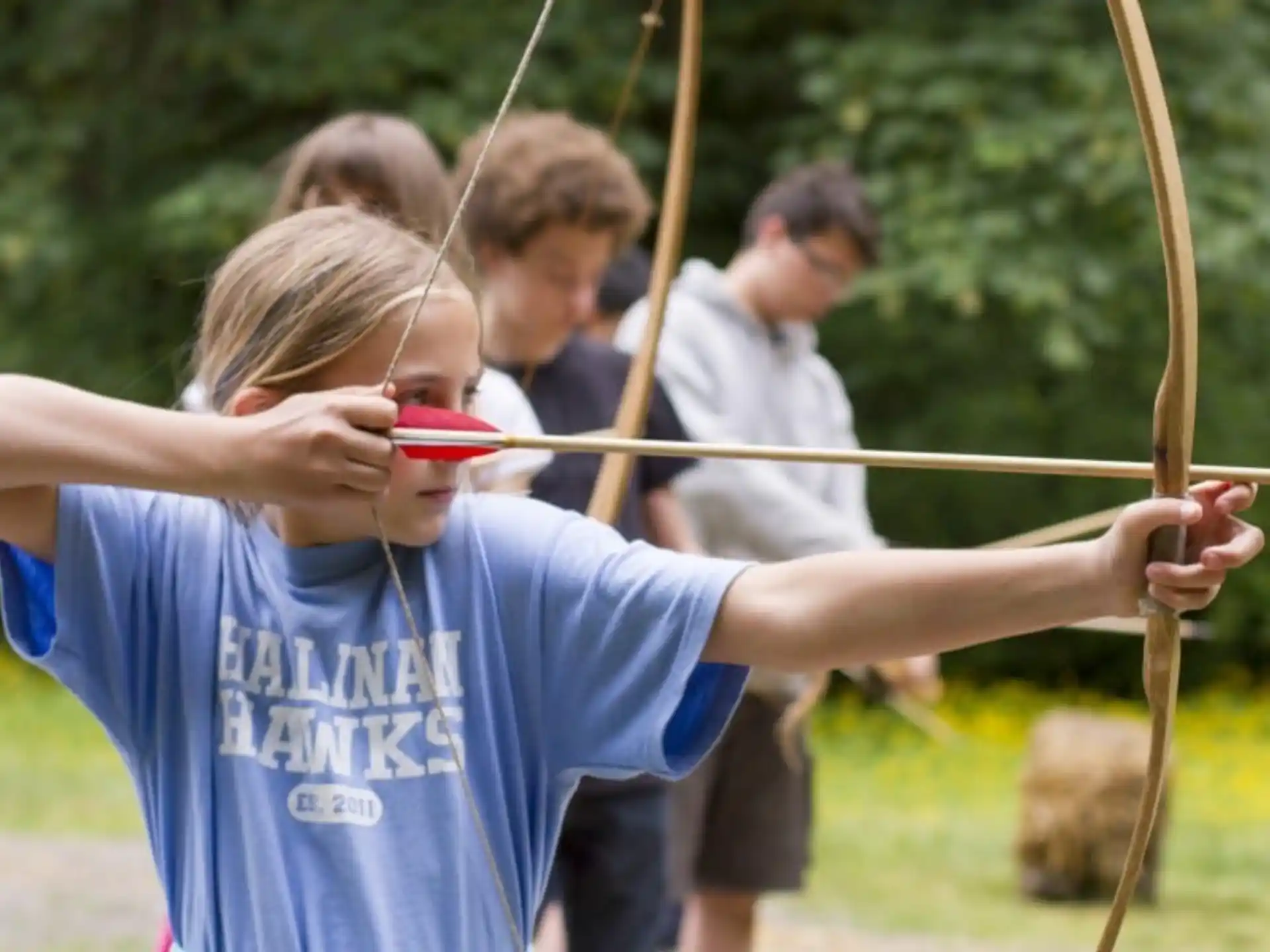 a group of people holding bows and arrows
