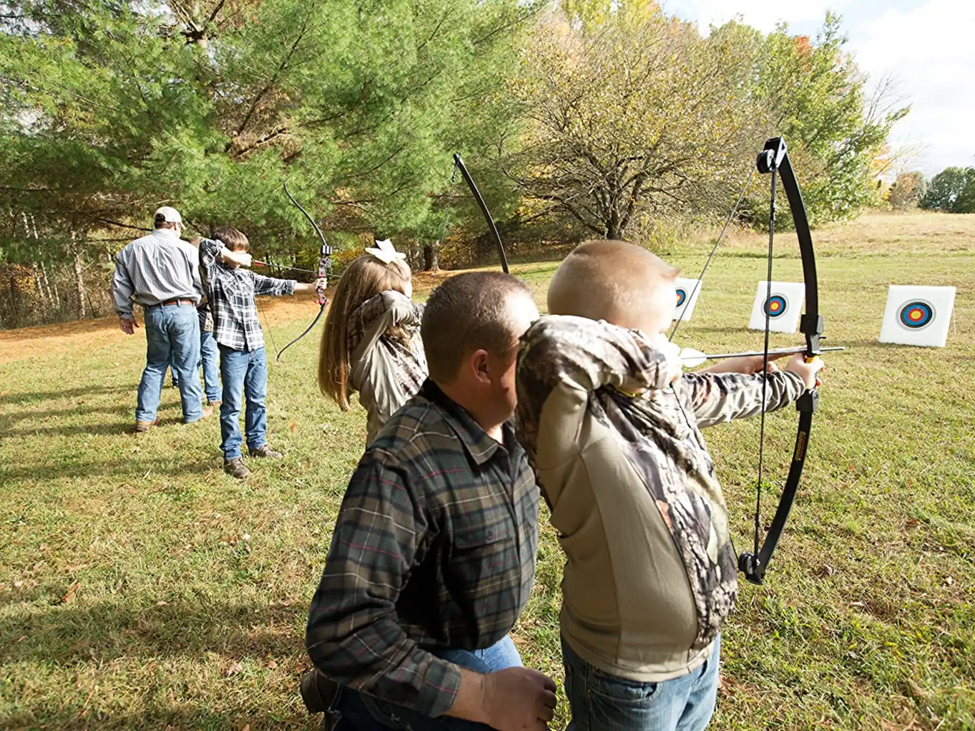 a group of people shooting bows